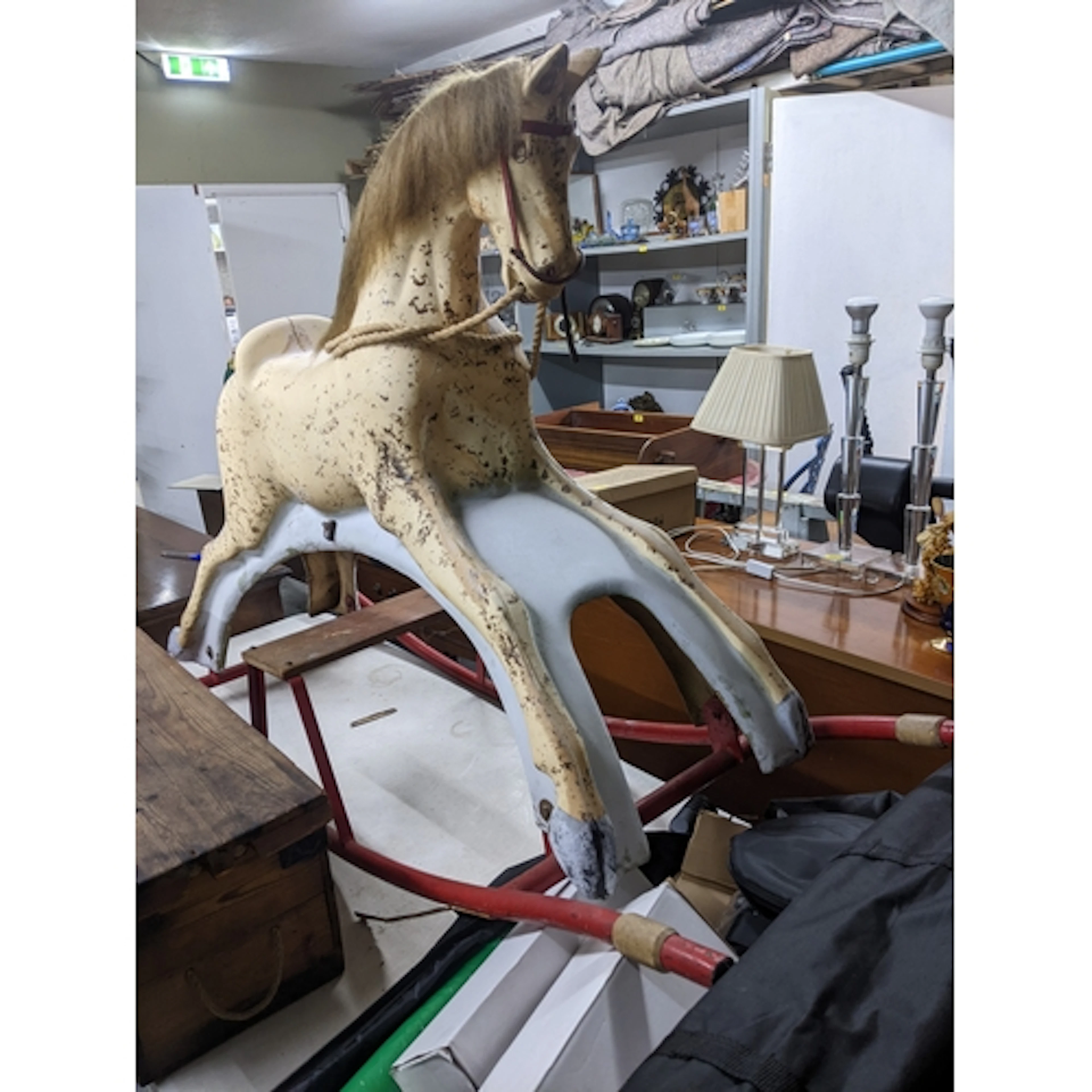 A vintage cream painted rocking horse on a red painted frame...