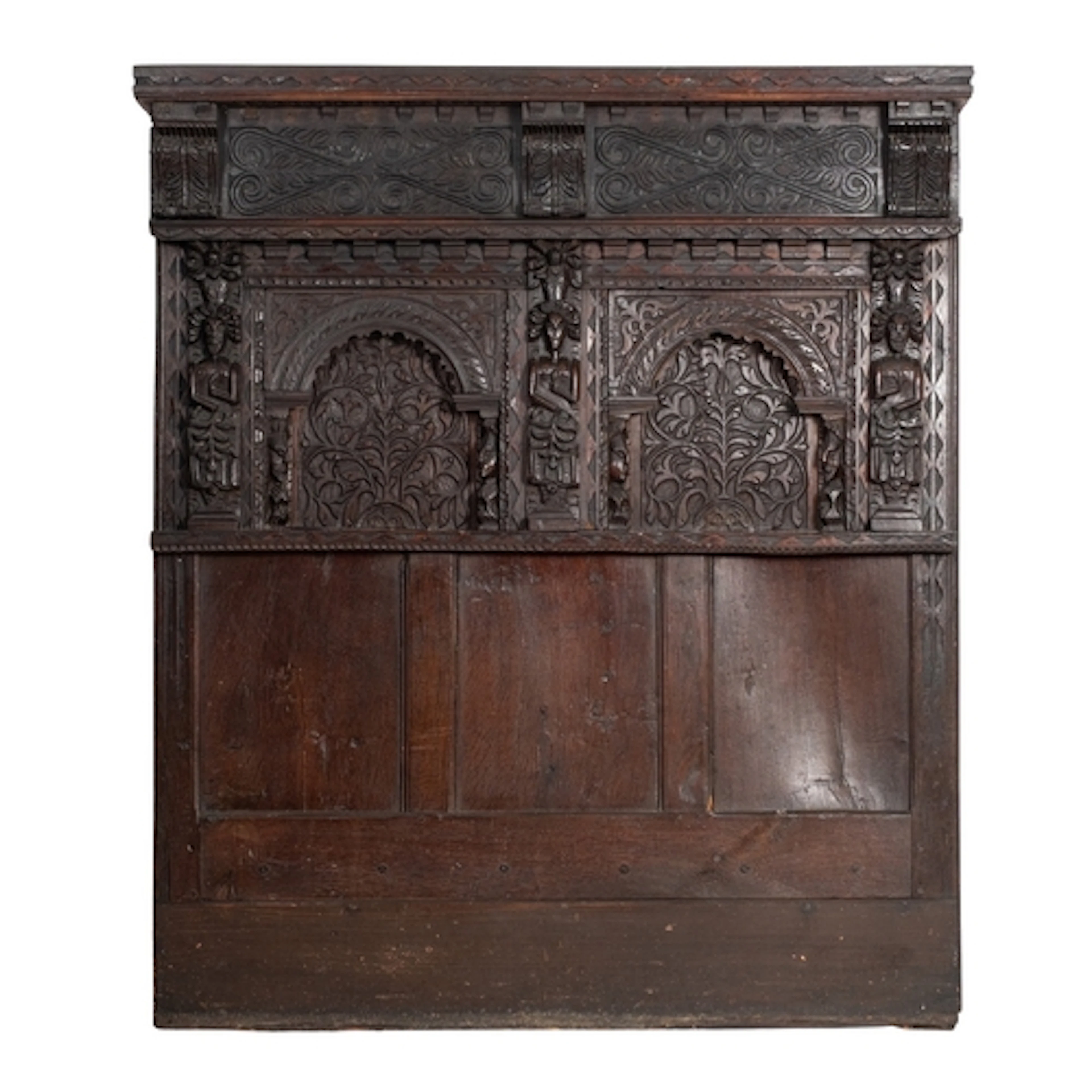 A relief carved oak headboard, elements 17th century and lat...