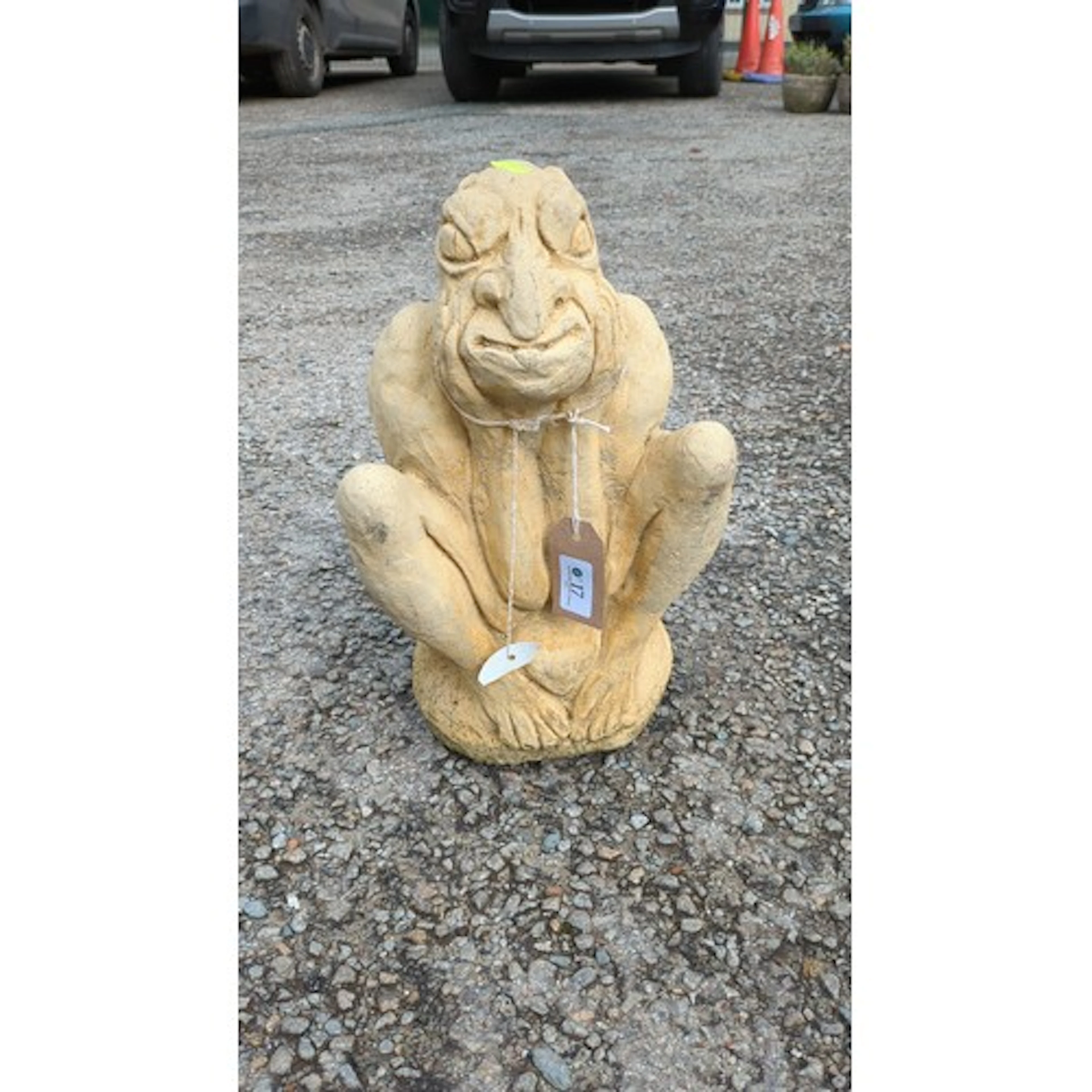 Concrete garden figure of a crouching grotesque, modelled wi...