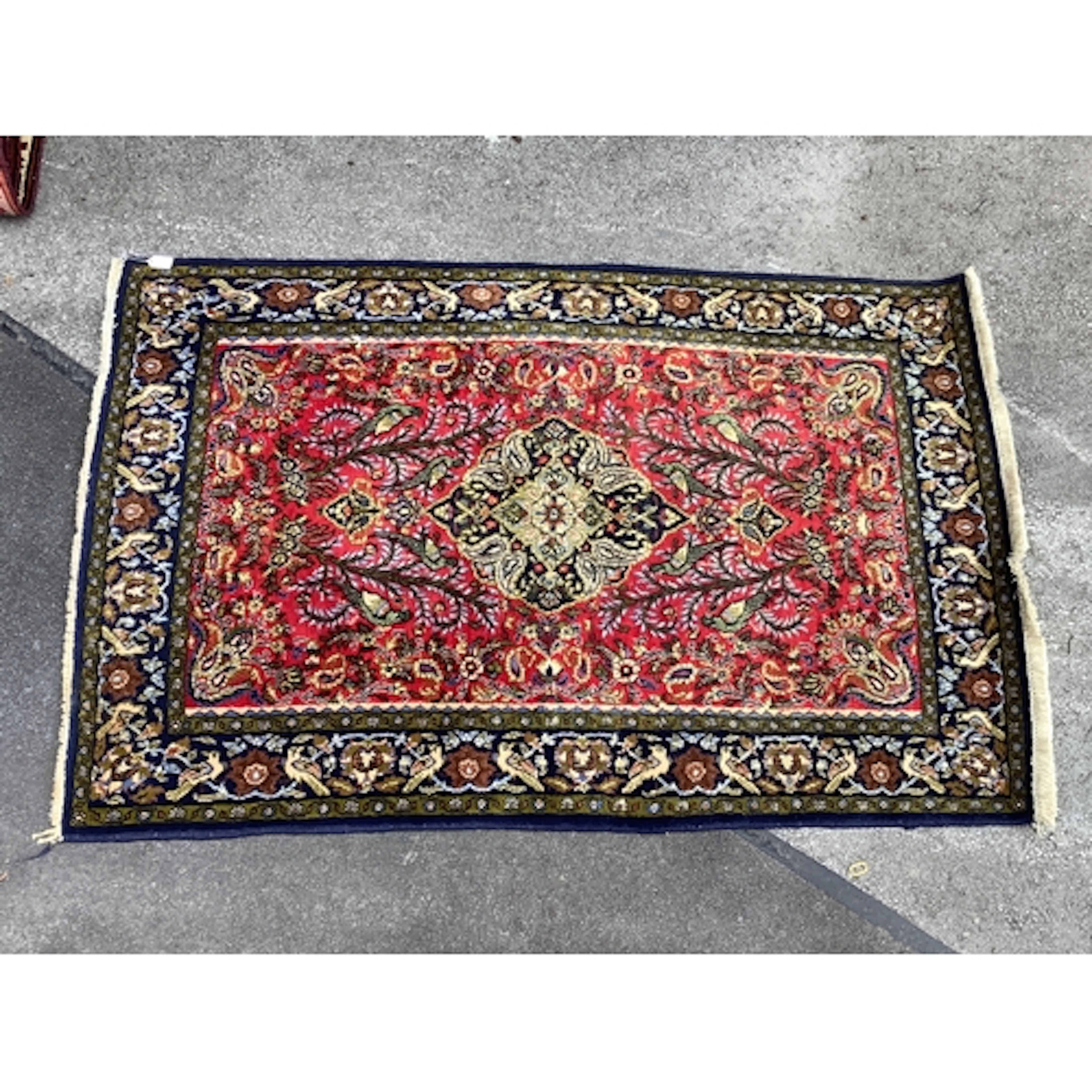 A Handmade Persian Ghom Rug, decorated with plants and birds...