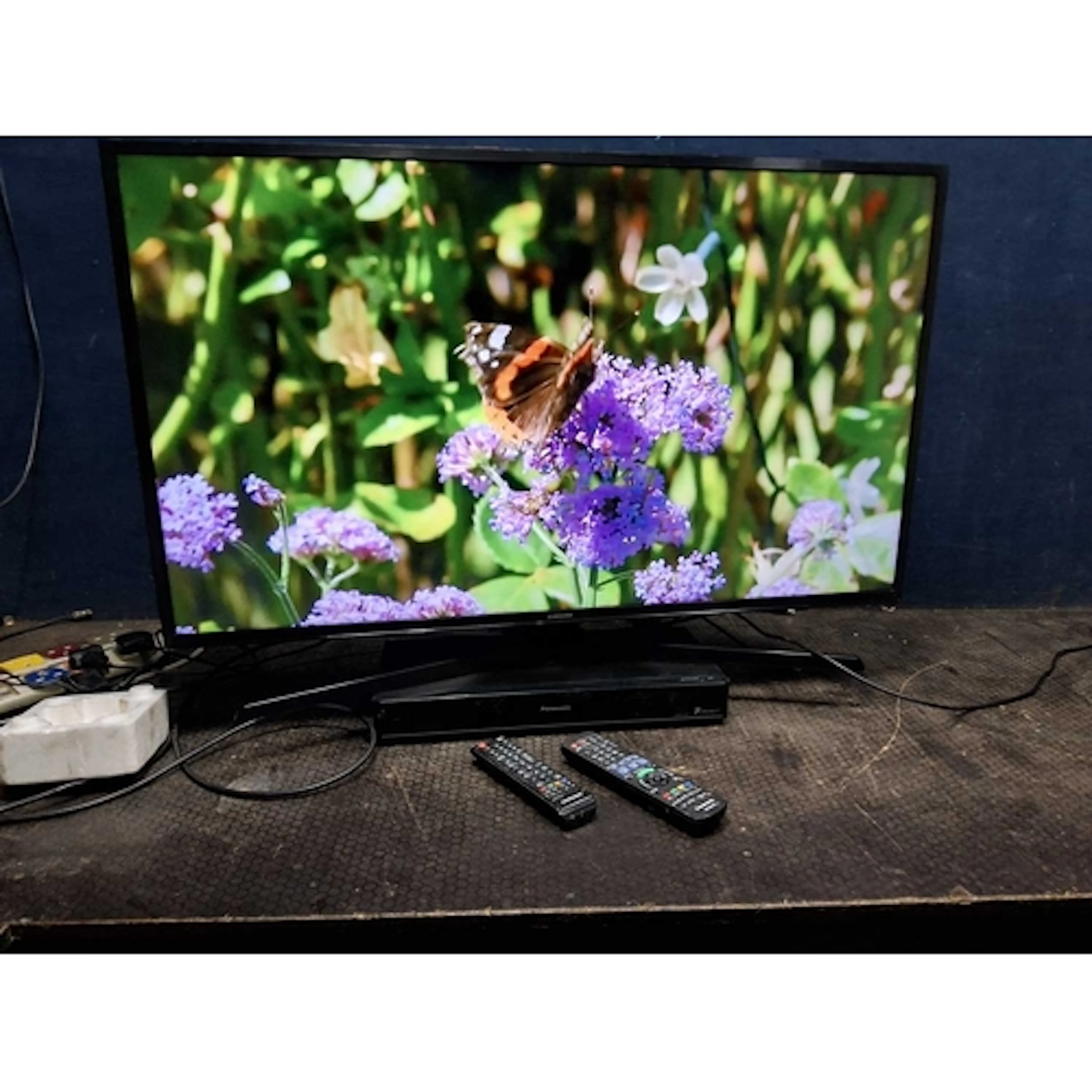 A SAMSUNG UE43KU6000K 43in SMART TV with remote and a Panaso...