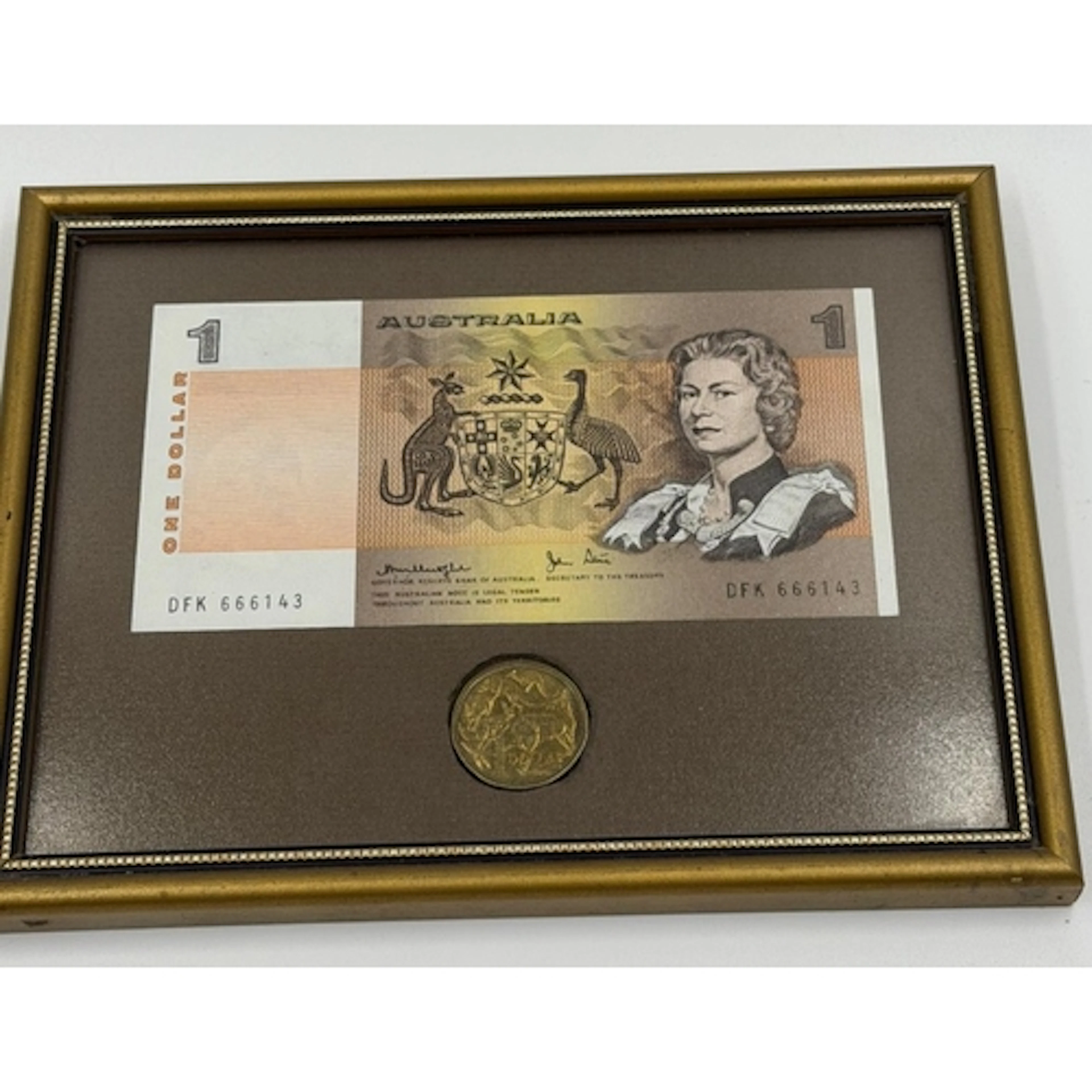 The framed Australian one-dollar banknote includes a corresp...