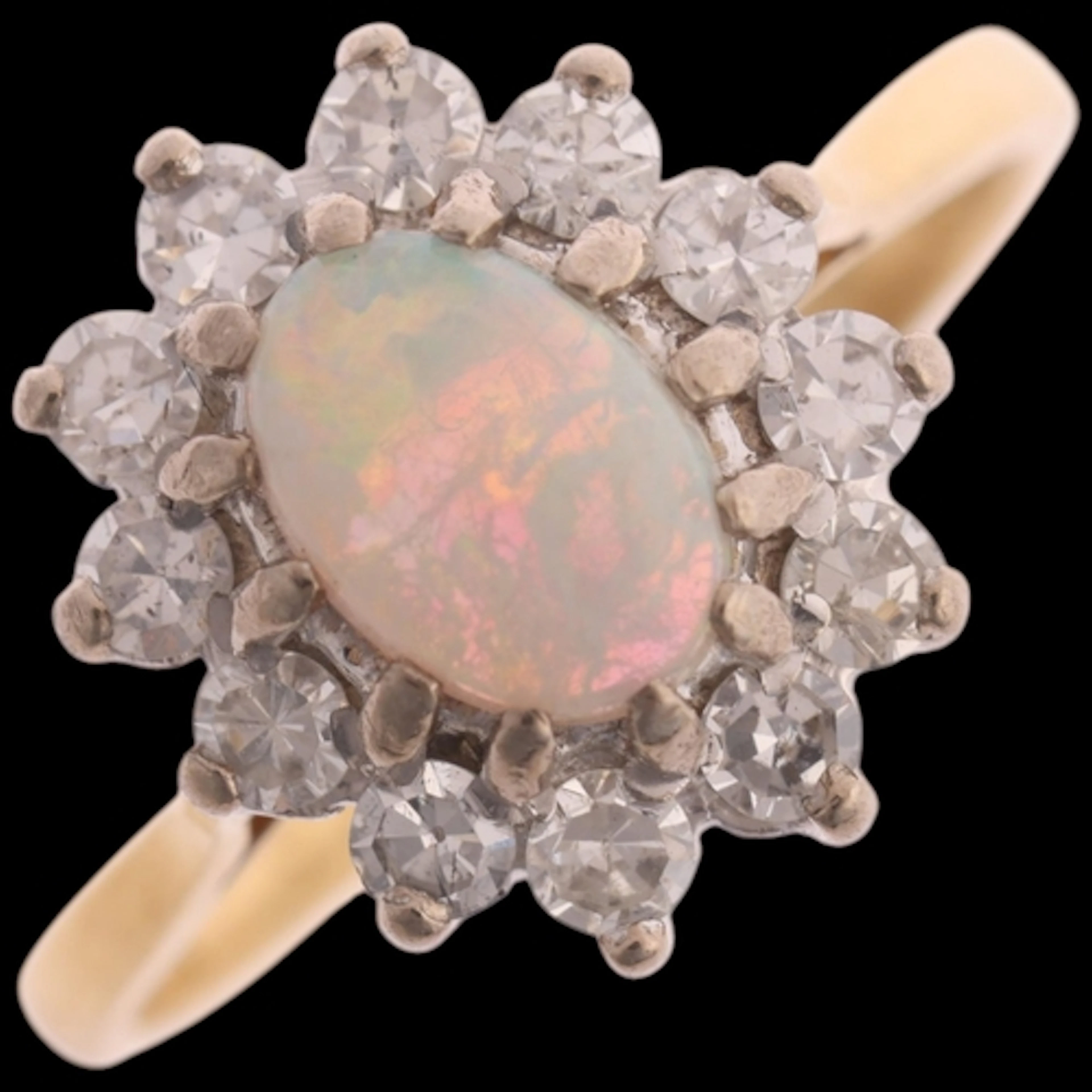 An 18ct gold opal and diamond cluster ring, claw set with 0....