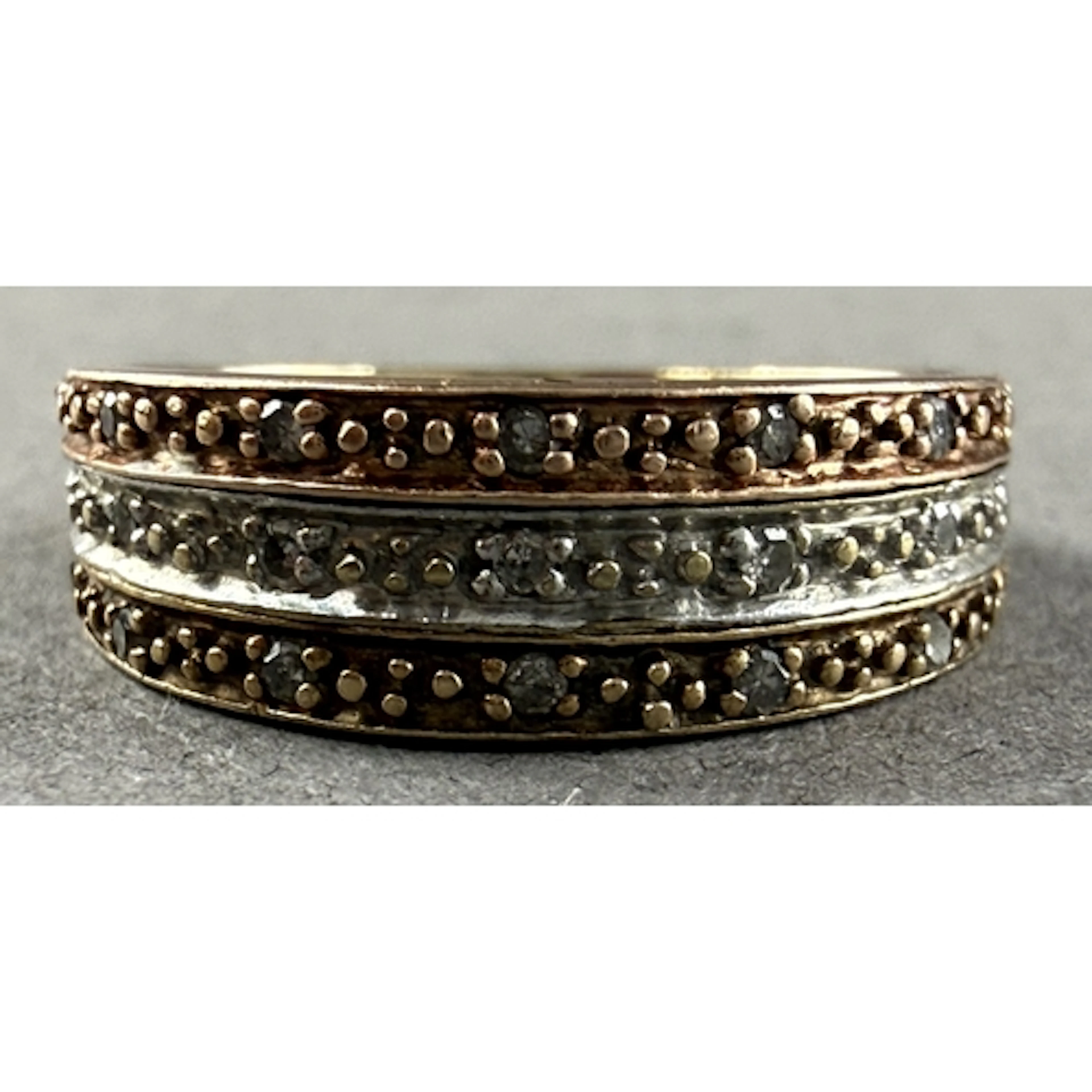 Jewellery: a 9ct gold and diamond ring, three bands of diffe...