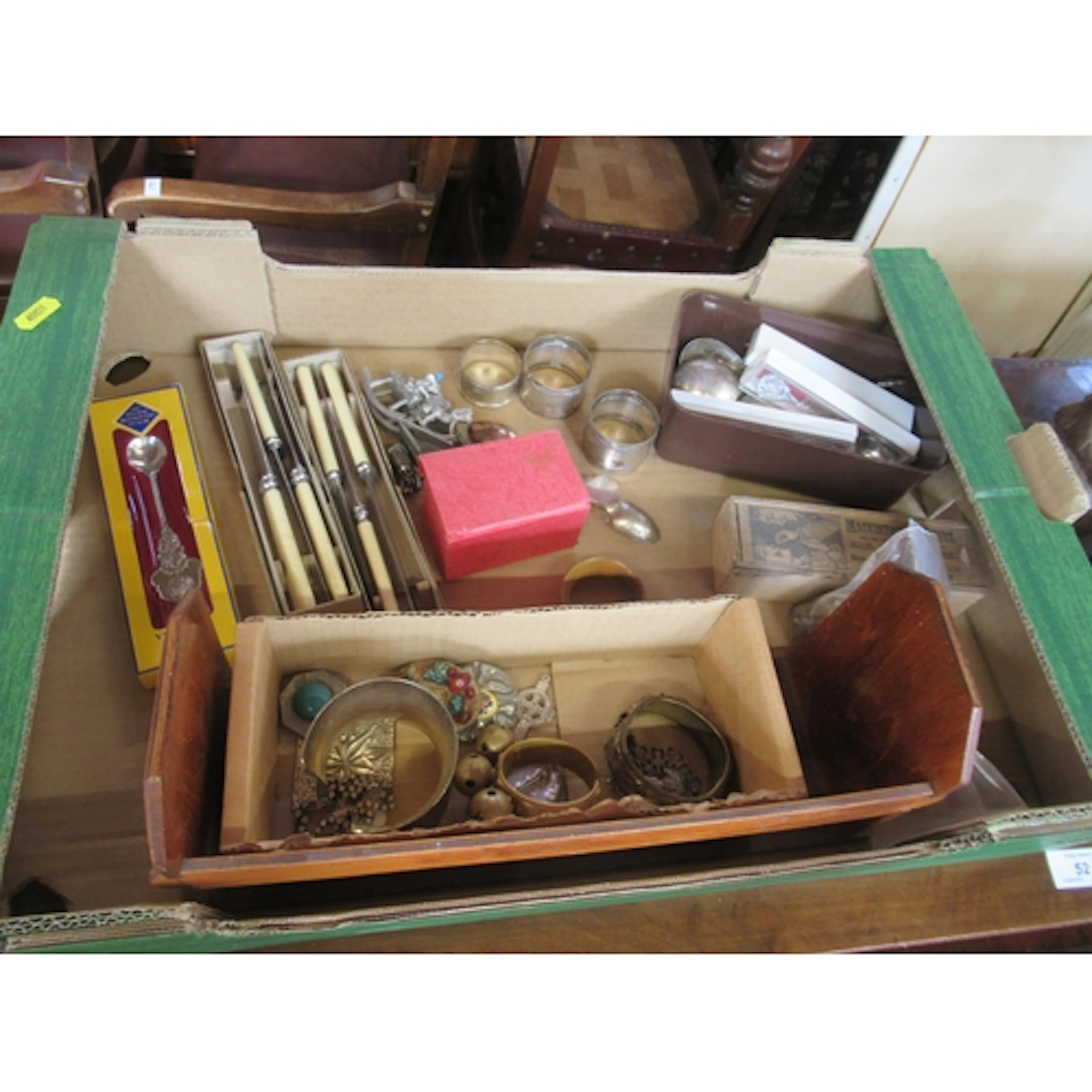 A box of assorted items, to include to silver napkin rings m...