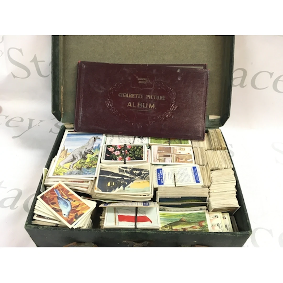 A case containing cigarette cards including Wills, Players e...