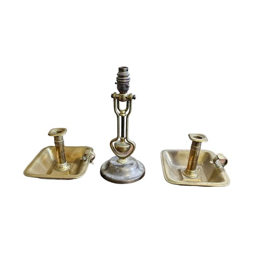 A PAIR OF 19TH CENTURY BRASS CHAMBER STICKS Along with a shi...