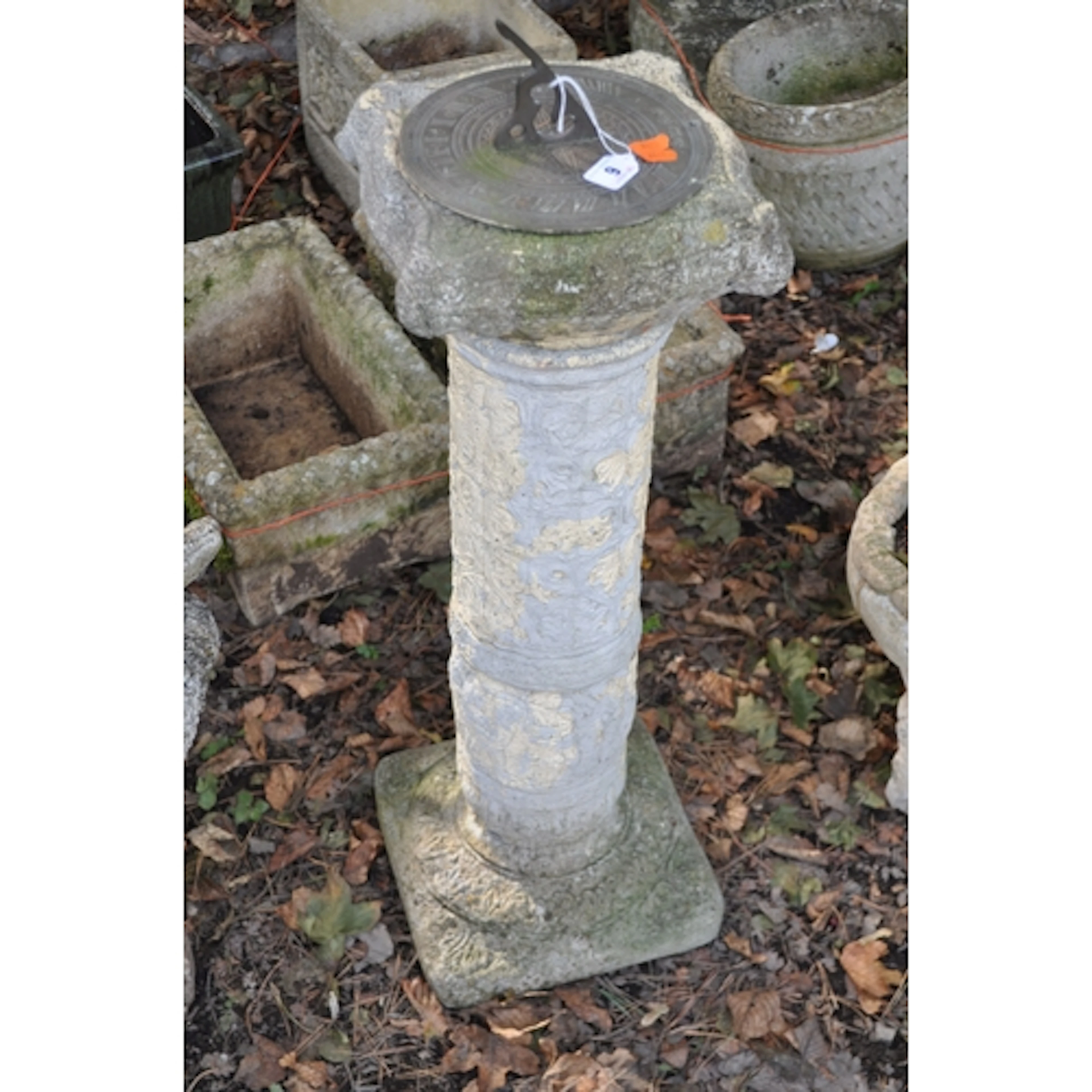 A CONCRETE SUNDIAL, in the form of an Egyptian column with a...