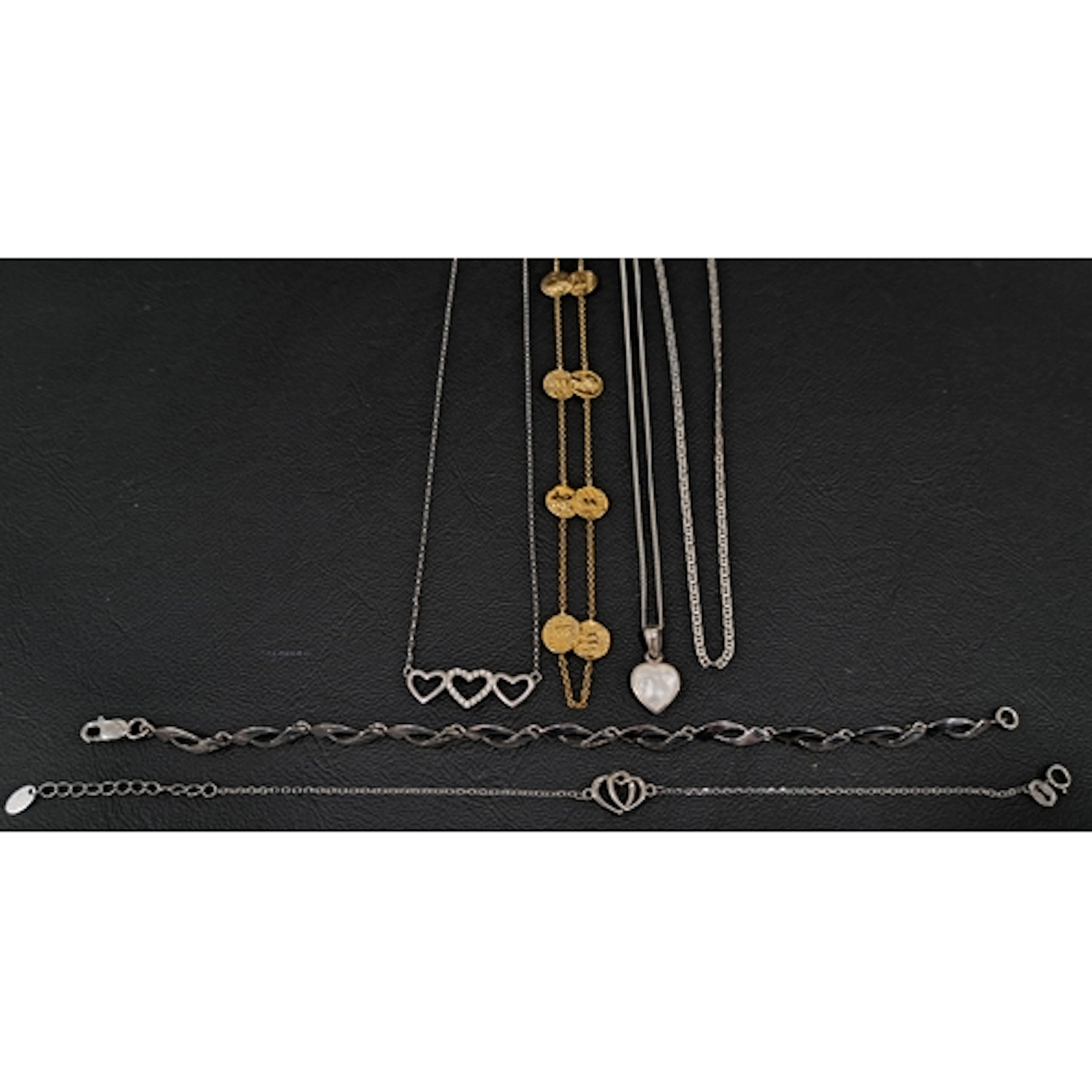 SELECTION OF SILVER JEWELLERY comprising a triple heart pend...