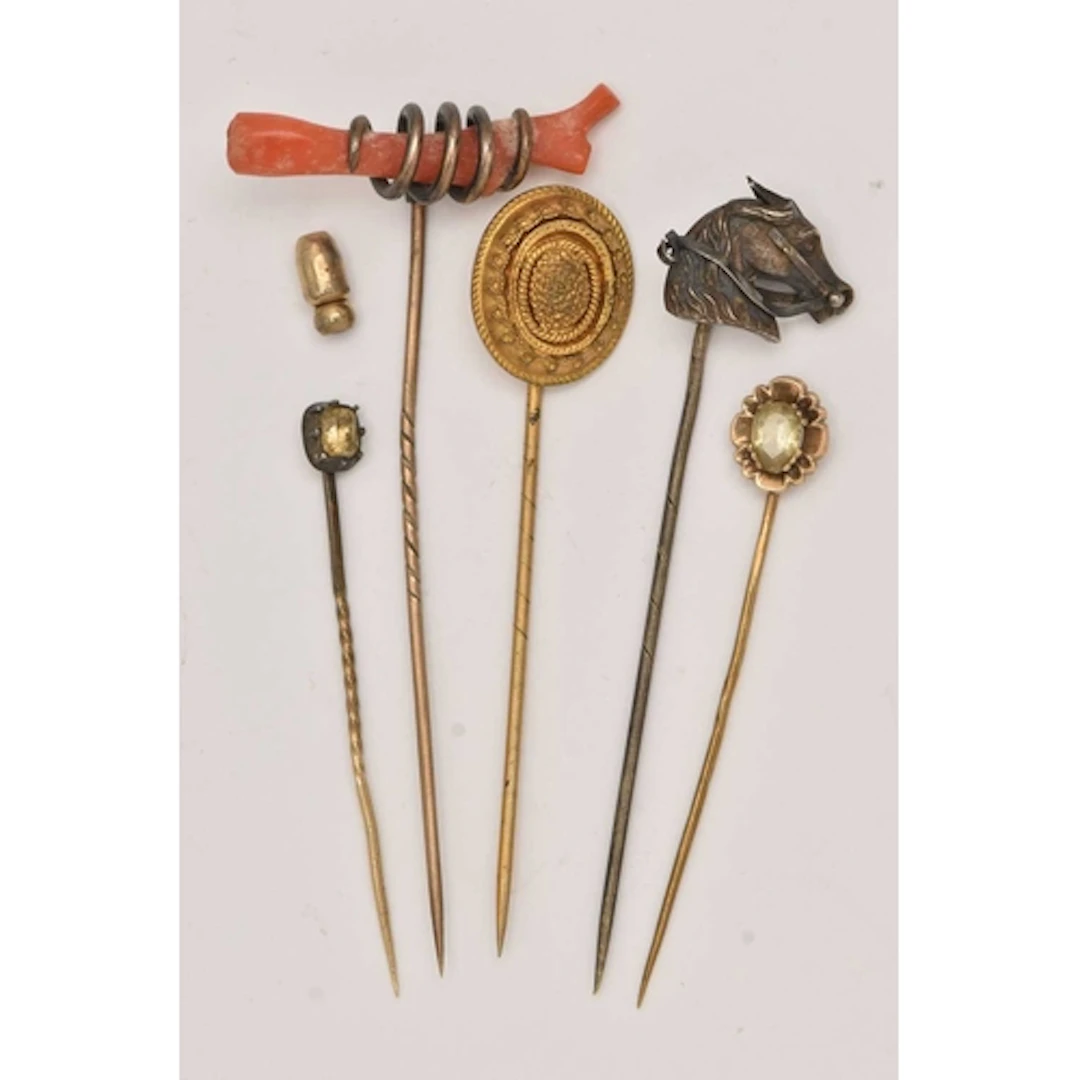 FIVE STICK PINS, to include a coral stick pin, a horse head ...