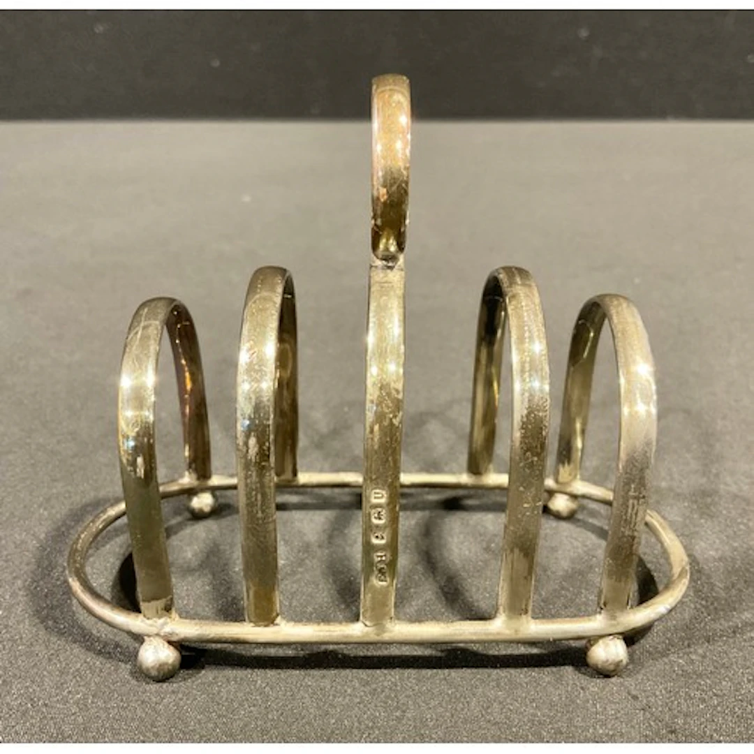 A George VI silver four-section toast rack, bun feet, 9cm hi...