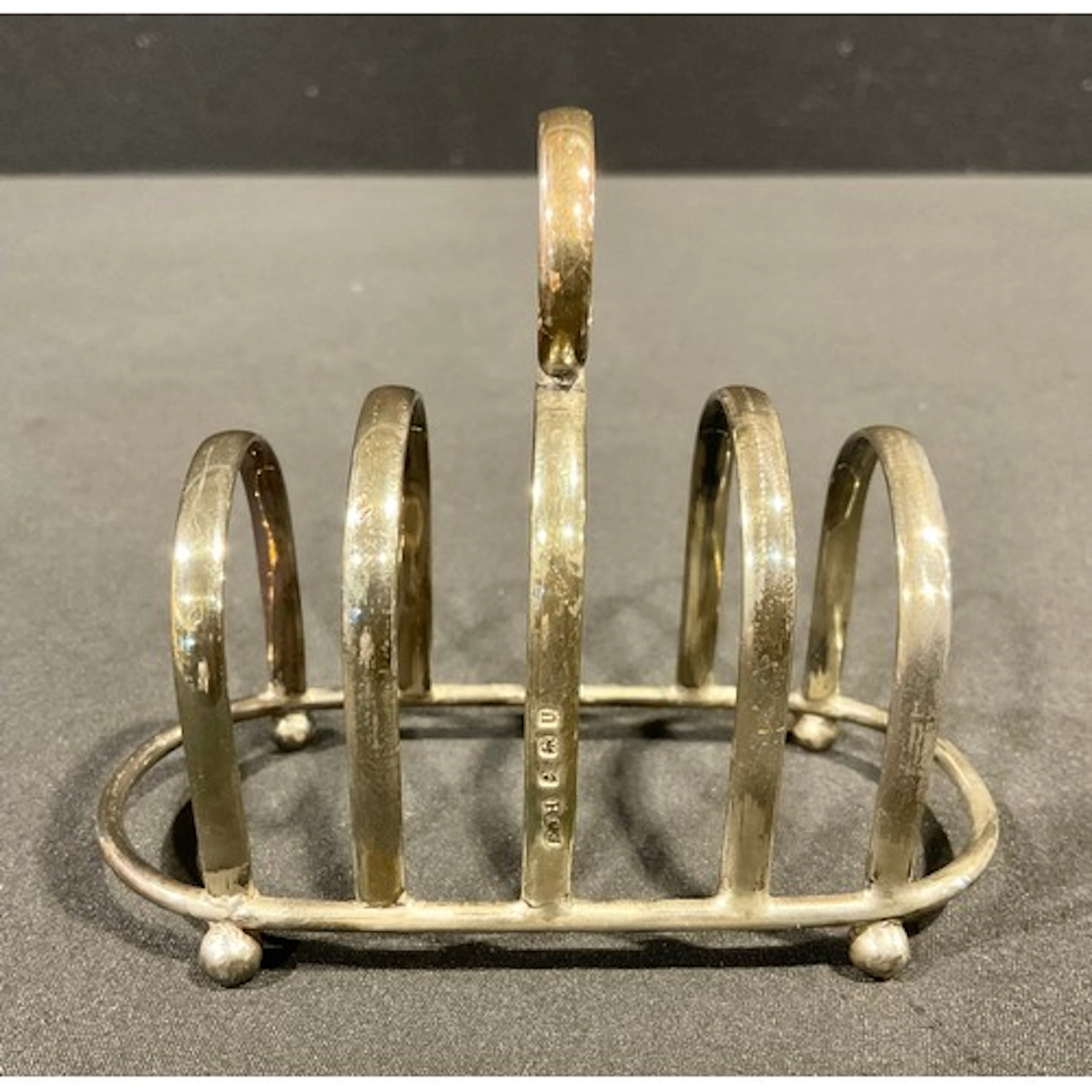 A George VI silver four-section toast rack, bun feet, 9cm hi...