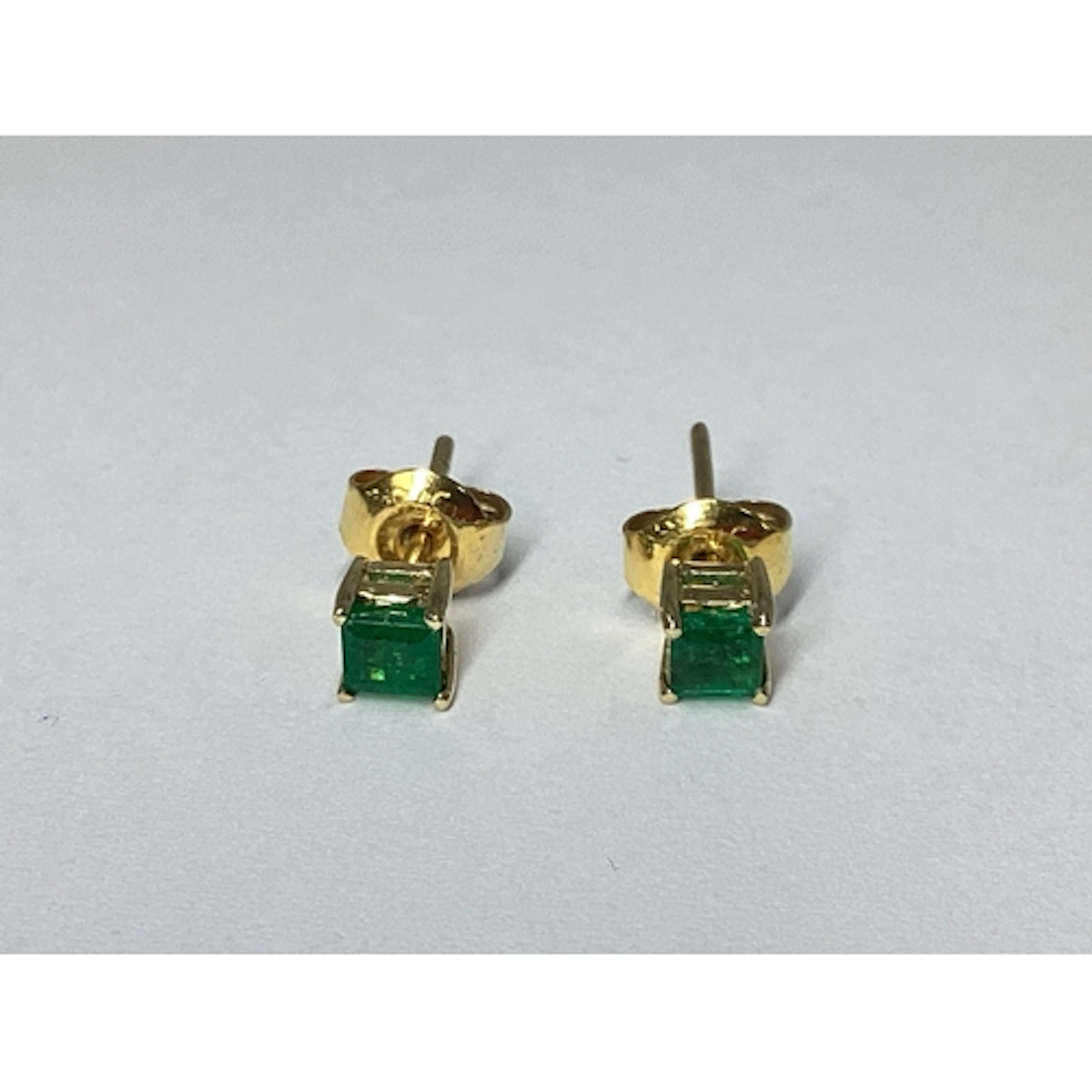 A Pair of Dainty Emerald Single Stone Earstuds, each square ...