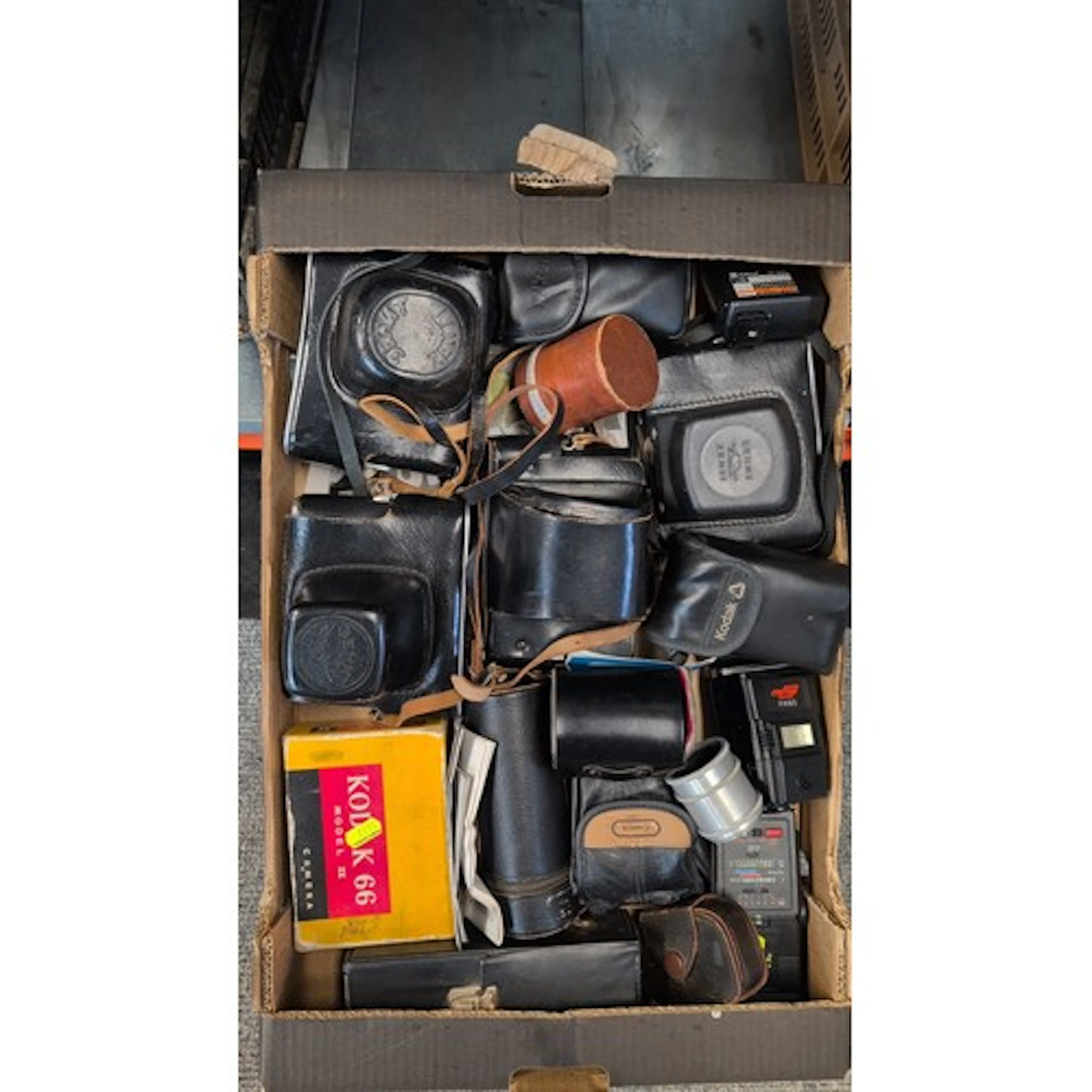An assortment of cameras and accessories, including a Zenit ...