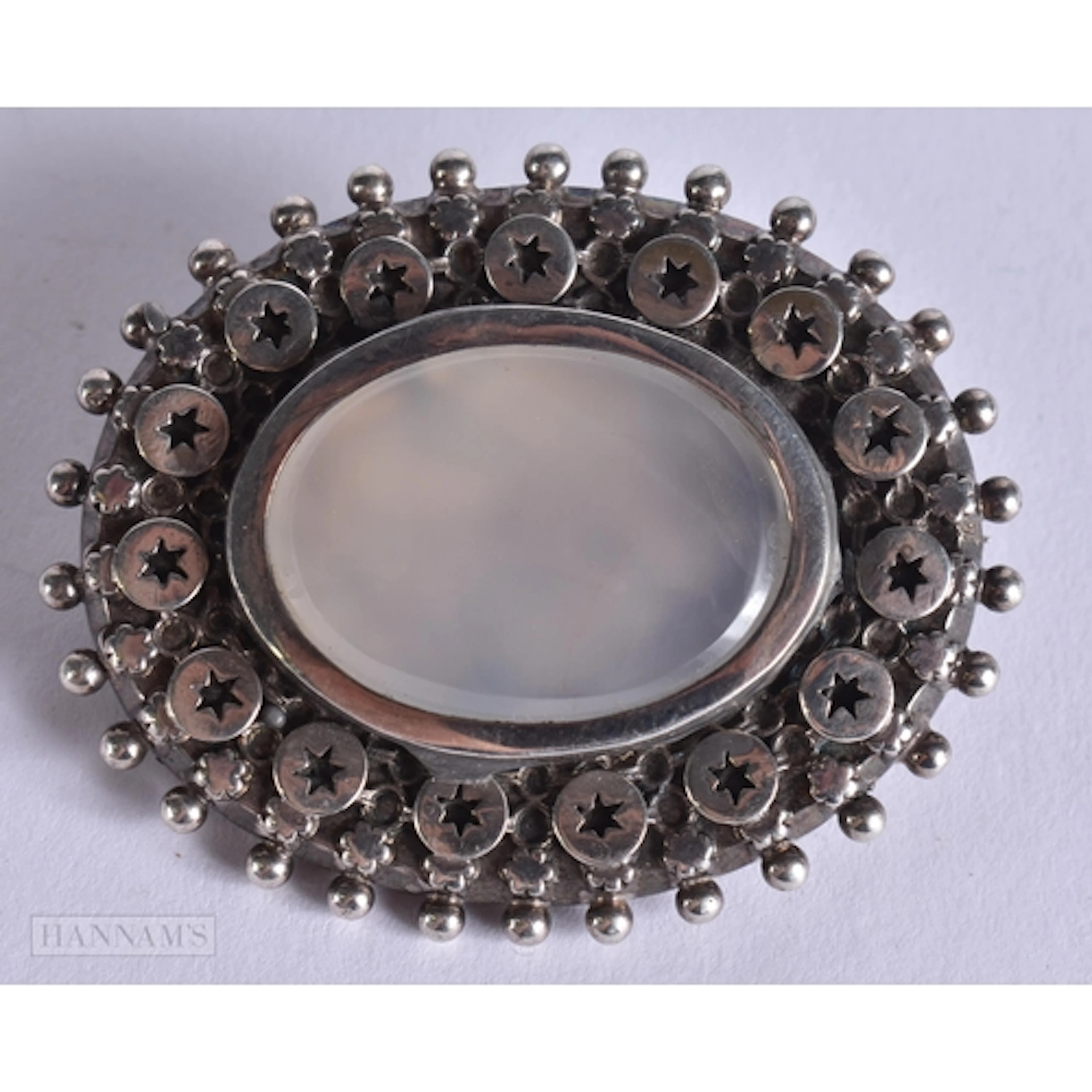 AN ANTIQUE SILVER AND MOONSTONE BROOCH. 20 grams. 5 cm x 4 c...
