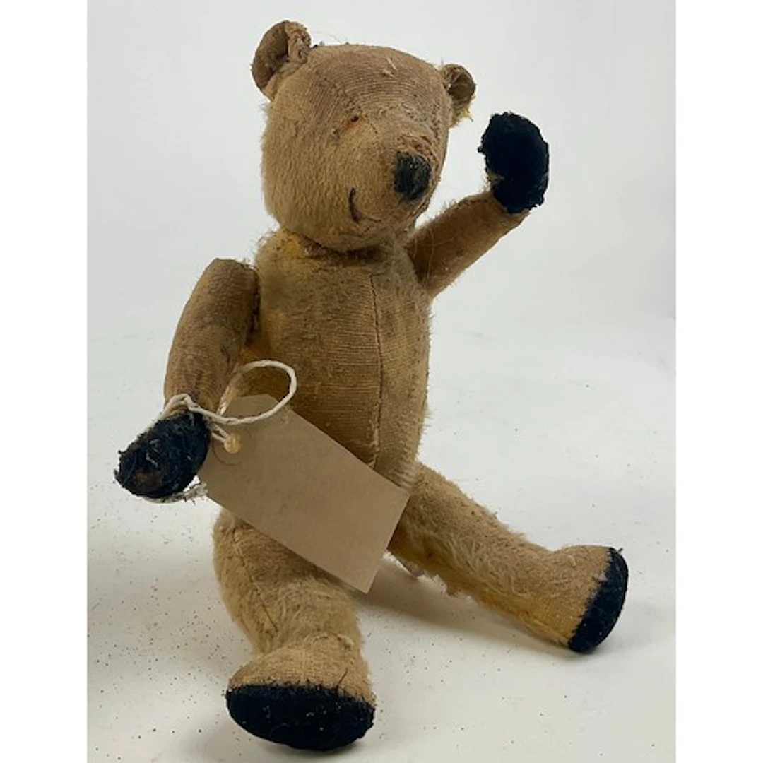 A well-loved early 20th century blonde mohair jointed bear, ...