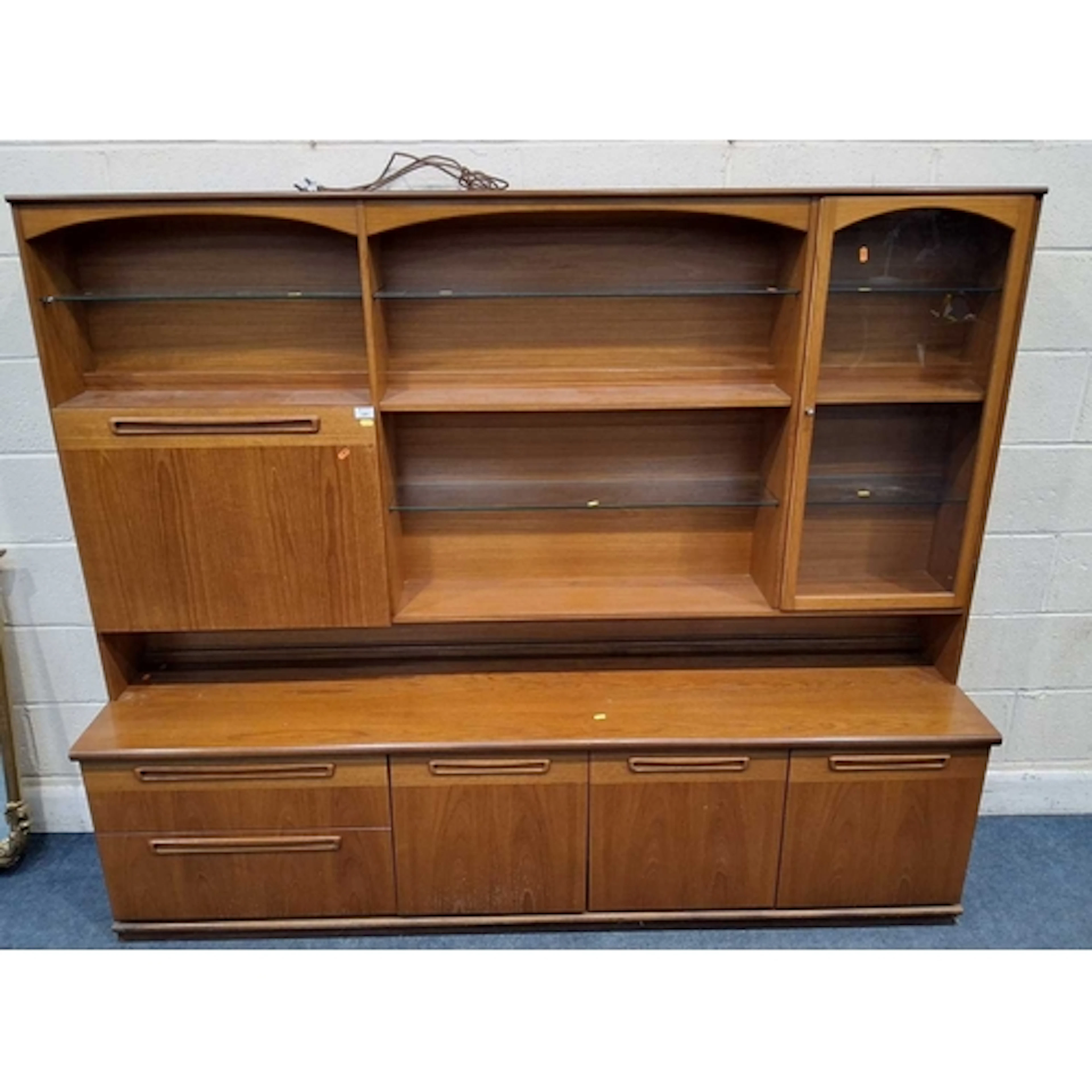 MEREDEW, A MID-CENTURY TEAK WALL UNIT, with an arangment of ...