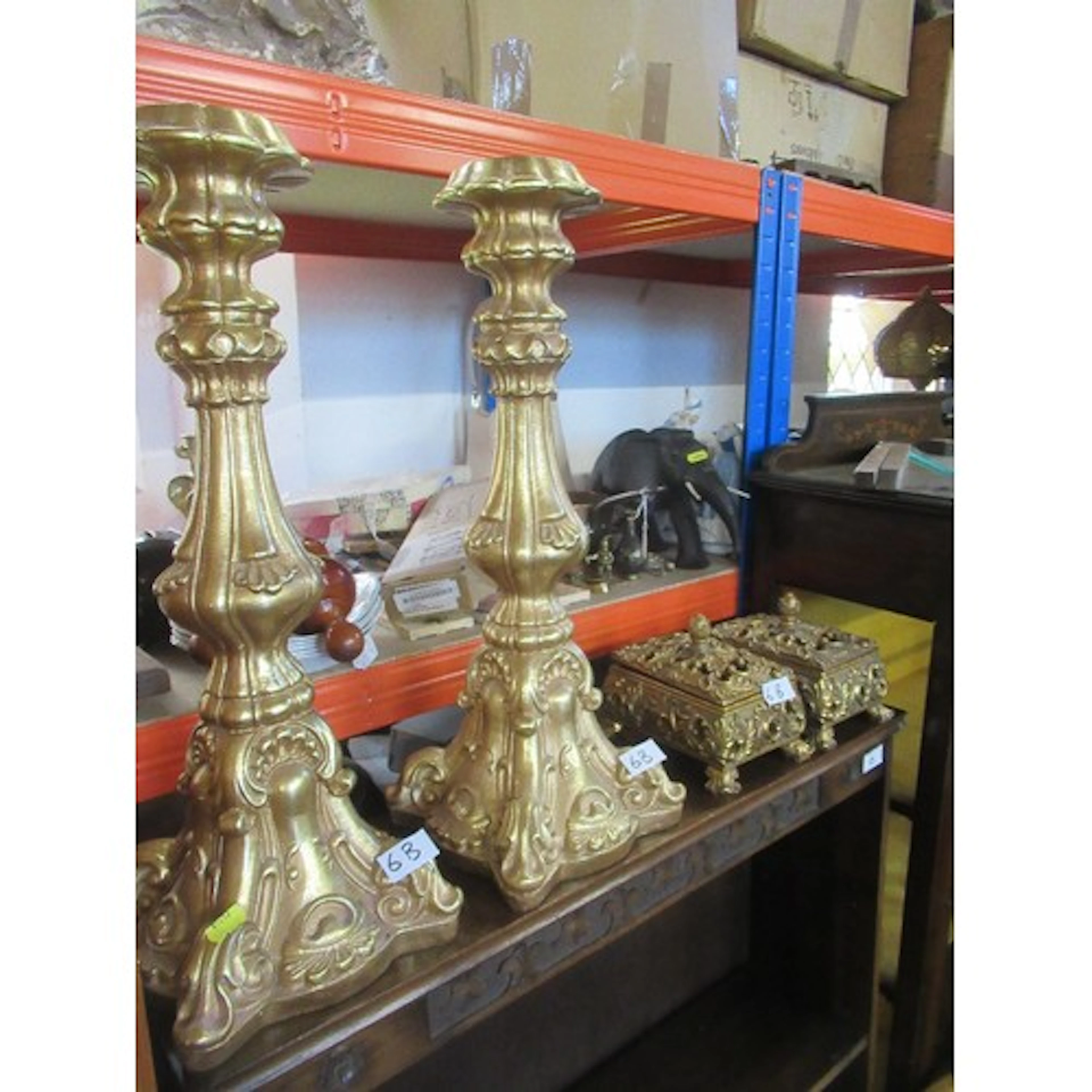 A pair of modern gilt candle stands together with a pair of ...