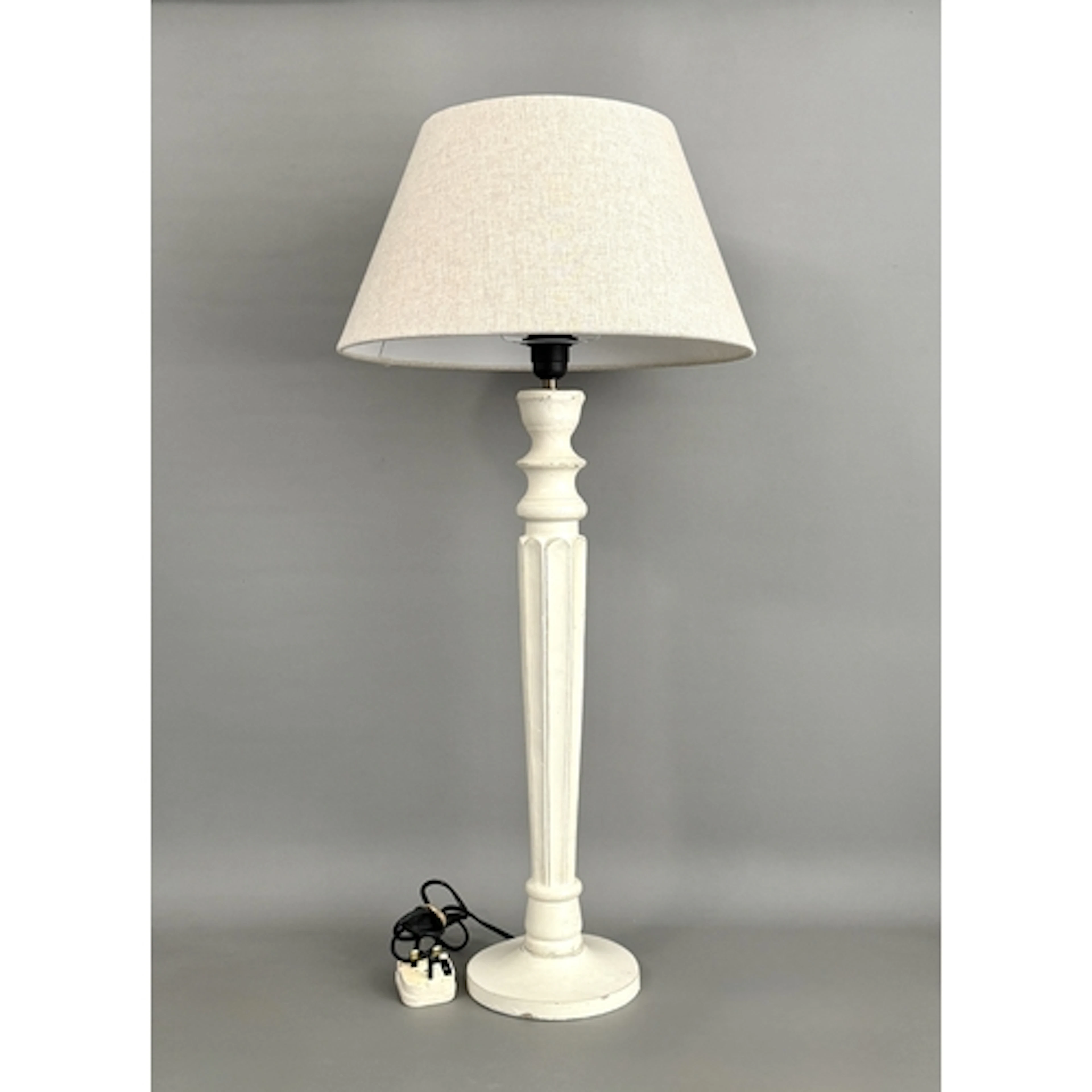 A contemporary cream painted wooden table lamp - with a flut...