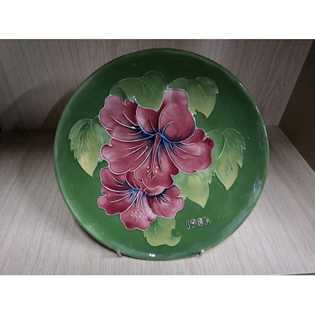 A MOORCROFT POTTERY 1983 HIBISCUS PLATE, tube-lined with red...