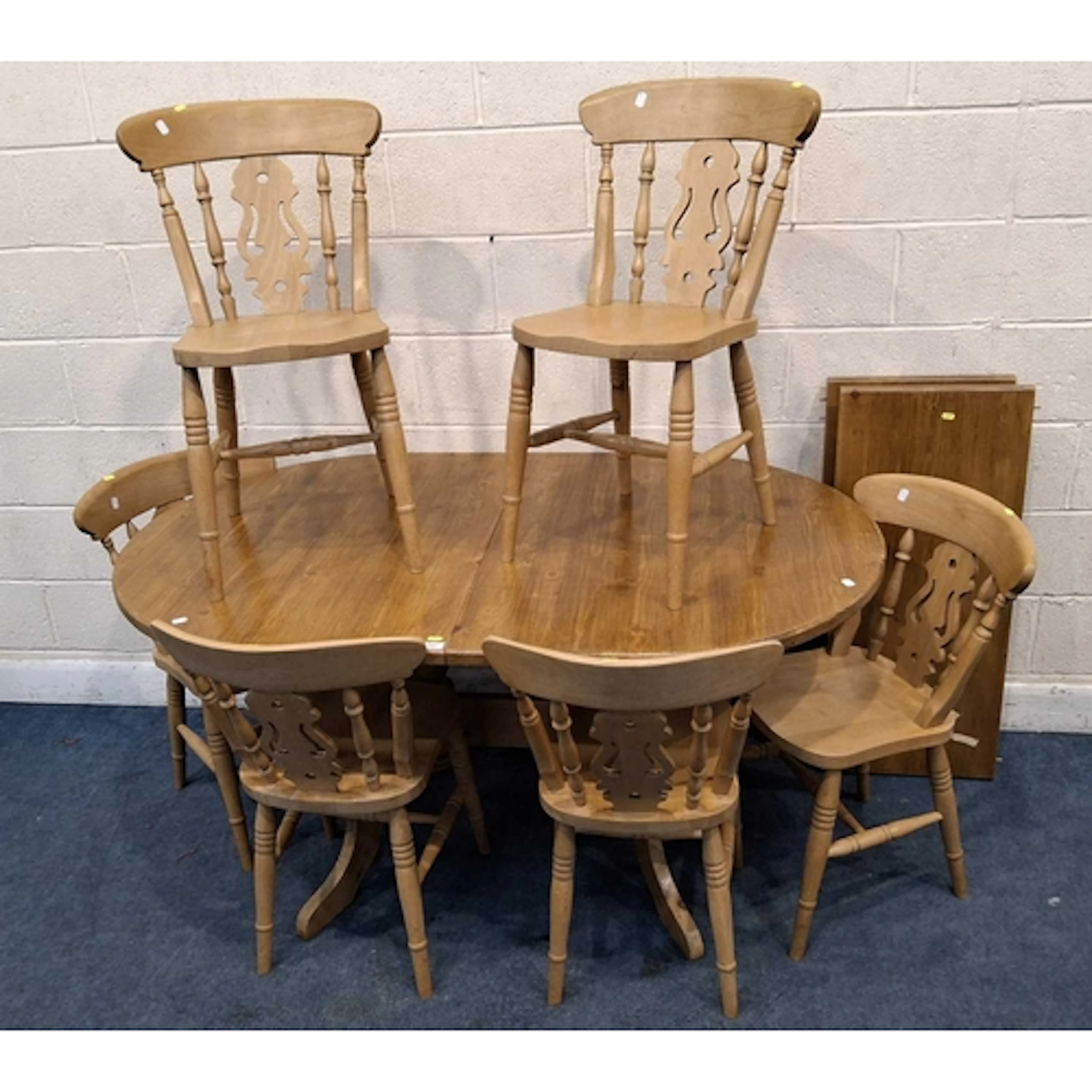 A MODERN PINE OVAL EXTENDING DINING TABLE, with two addition...