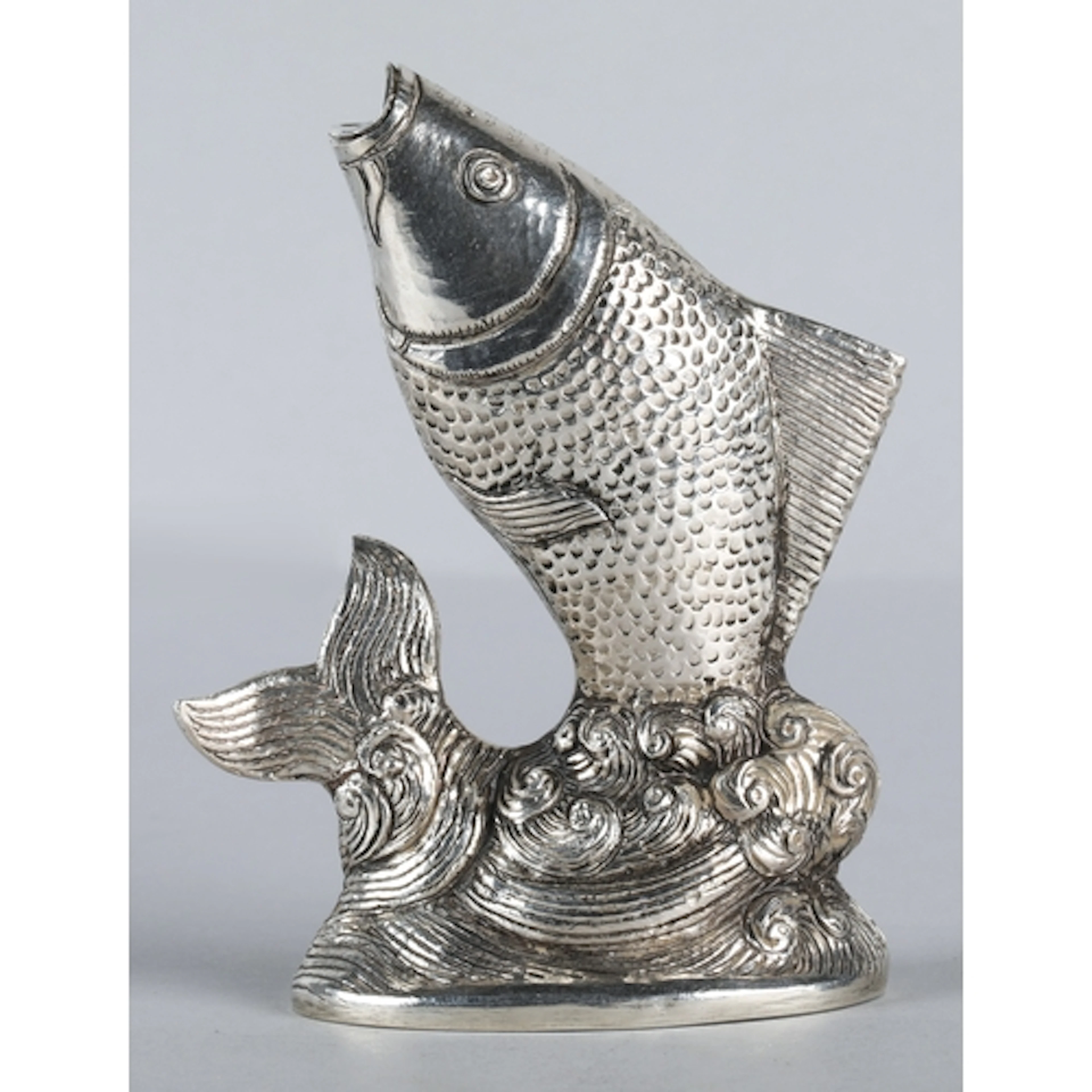 South East Asian silver coloured figure in the form of an ar...
