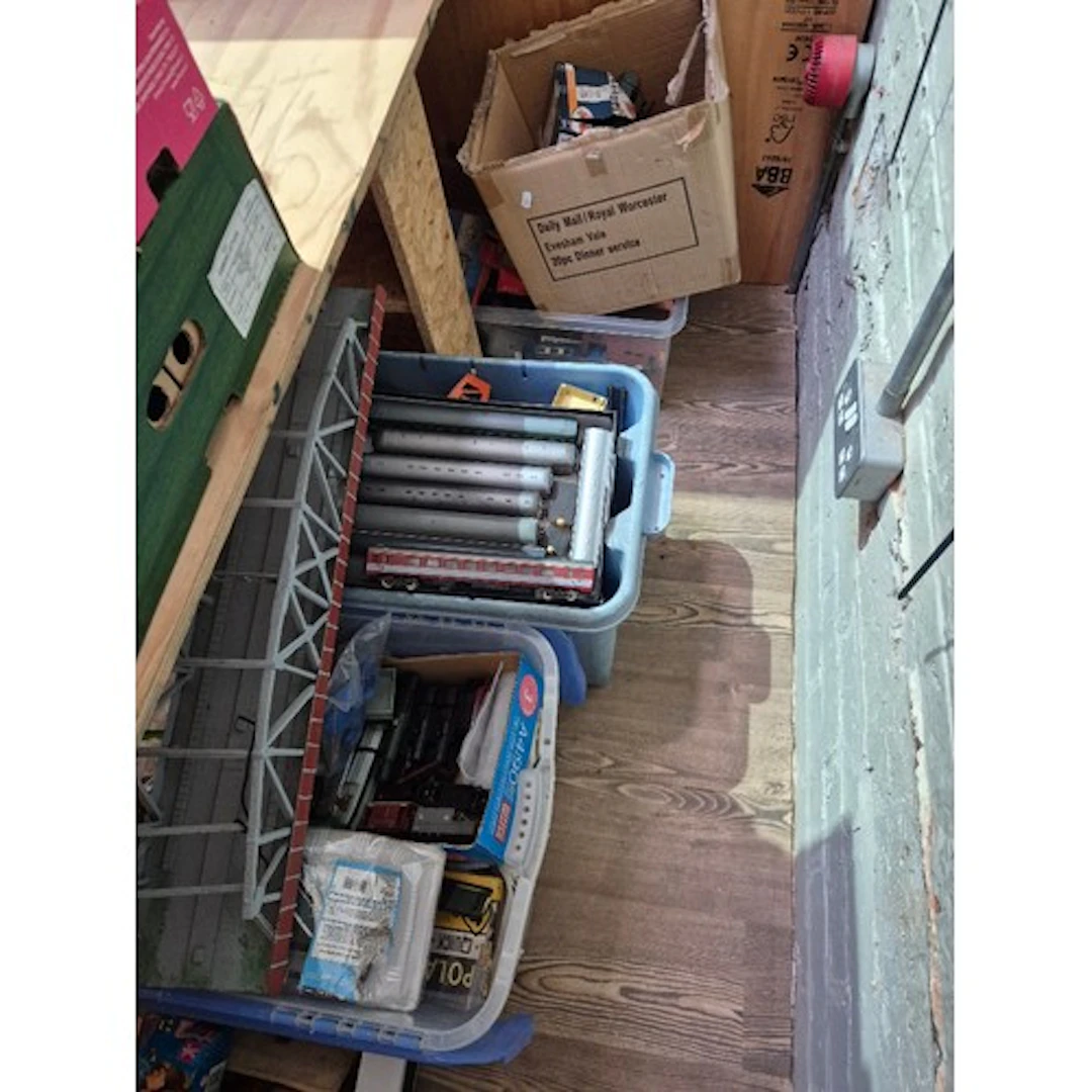 Four boxes of assorted model train items to include engines,...