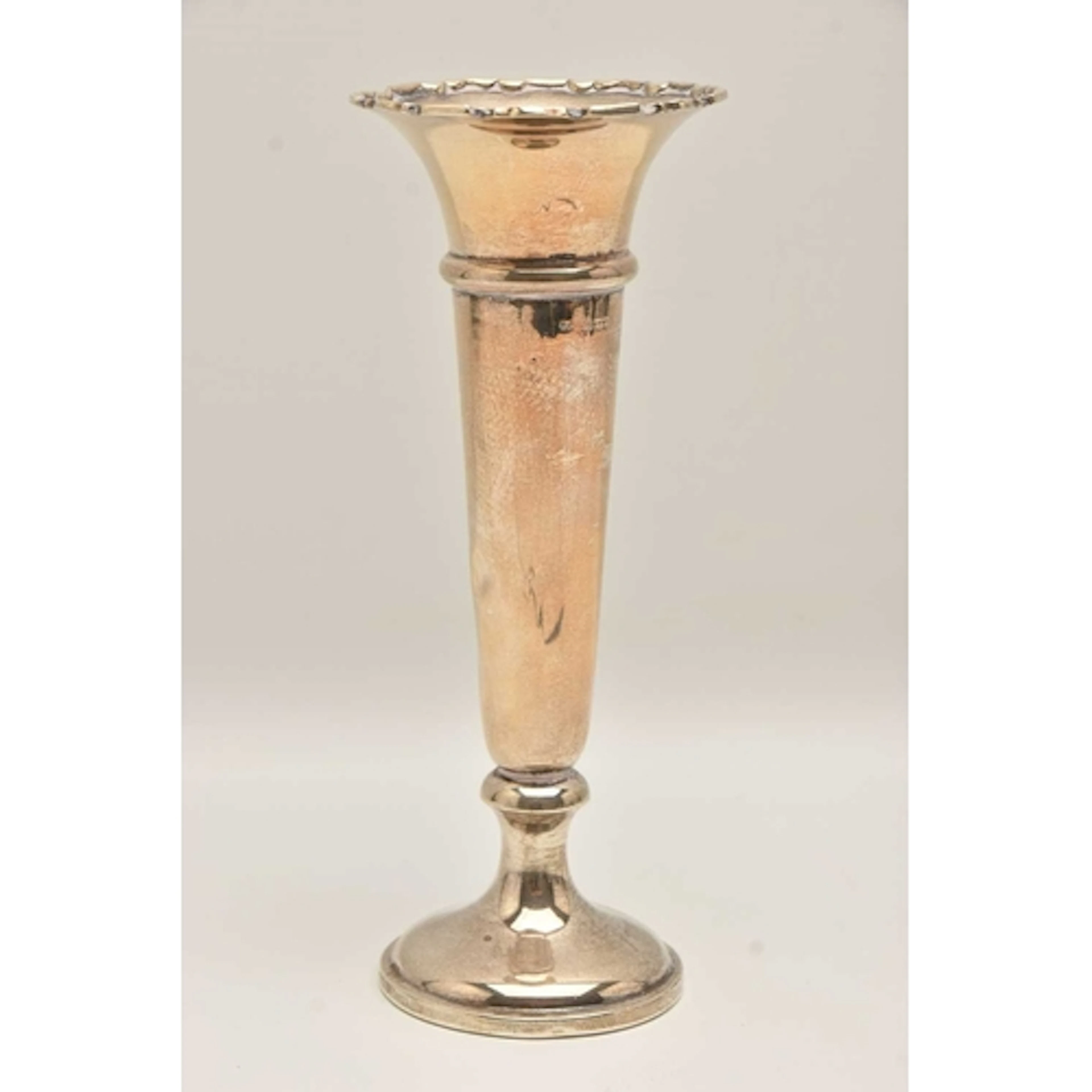 A GEORGE V SILVER VASE, polished tapering form with wavy rim...