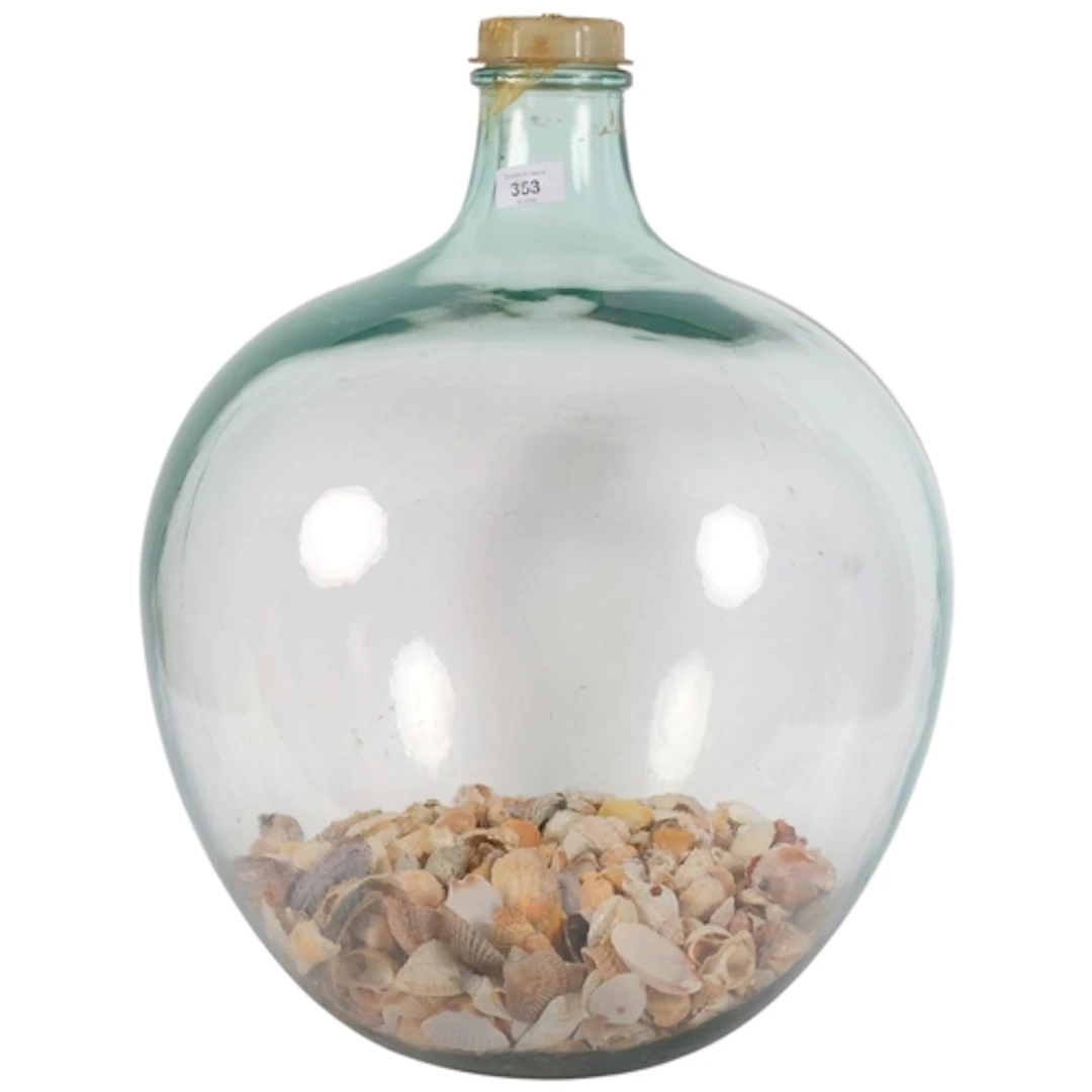 A large green glass carboy, holding a quantity of shells, H5...