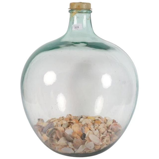 A large green glass carboy, holding a quantity of shells, H5...