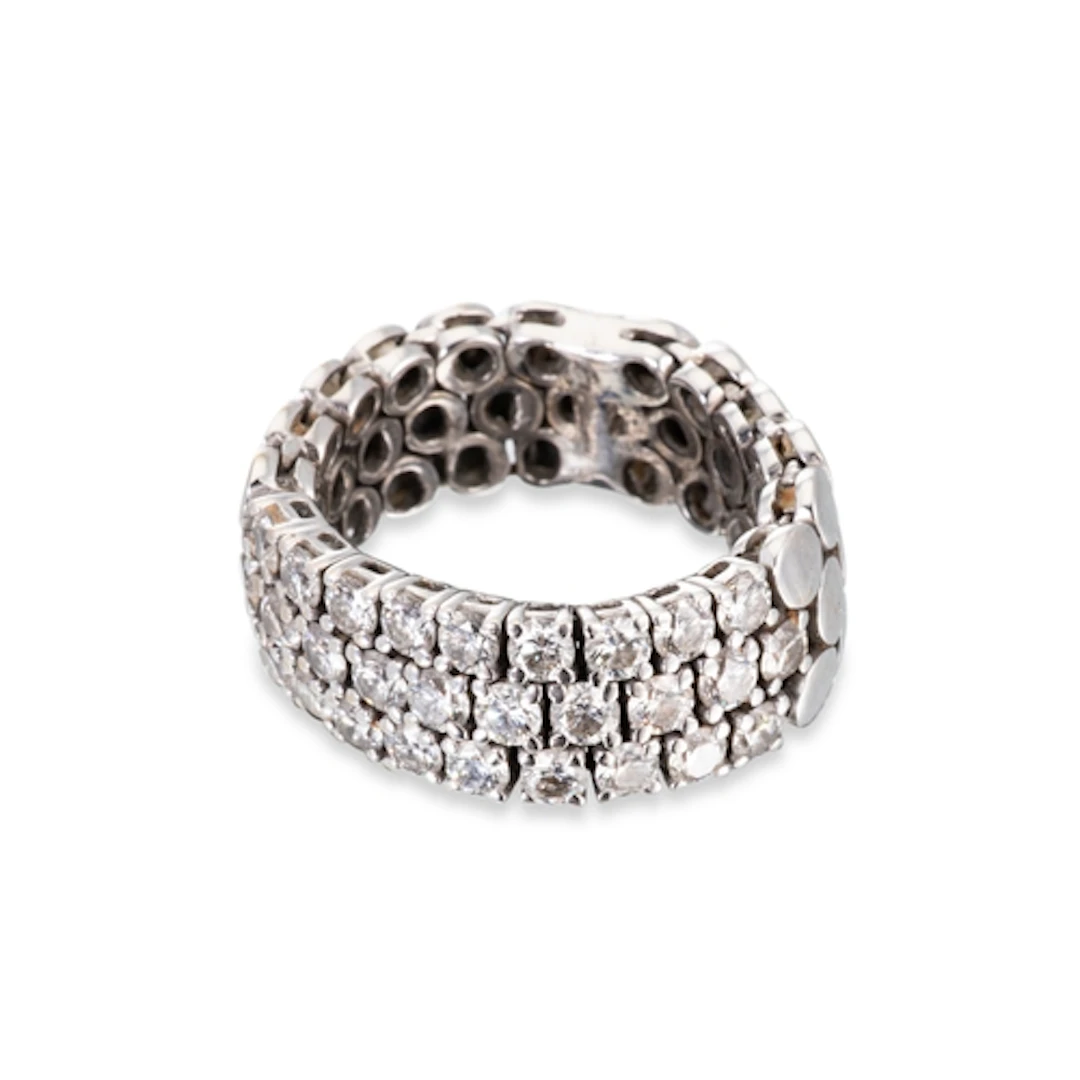 A DIAMOND SET FLEXIBLE BAND RING, XRF testing as 18ct white ...