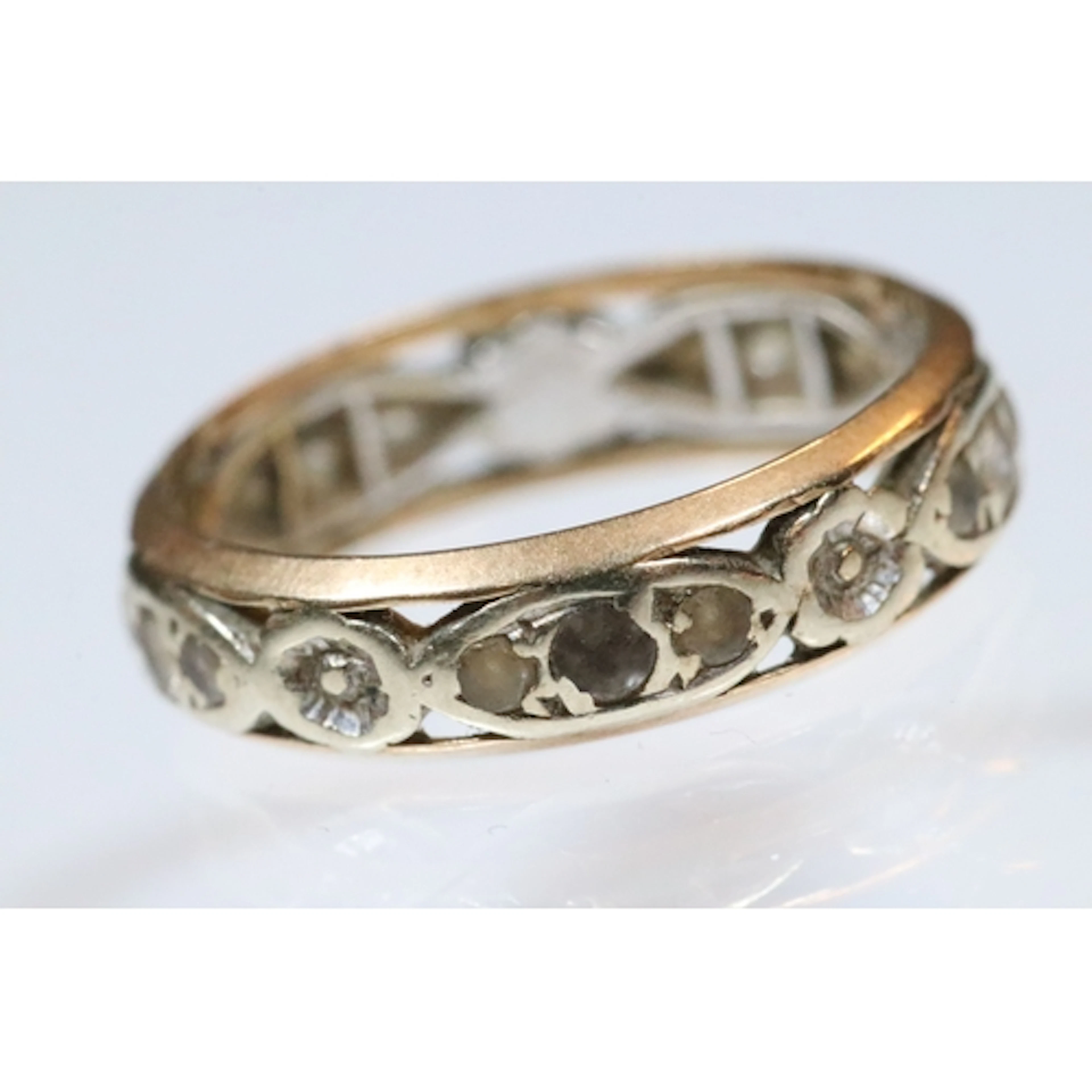 9ct gold eternity ring being set with white stones and pierc...