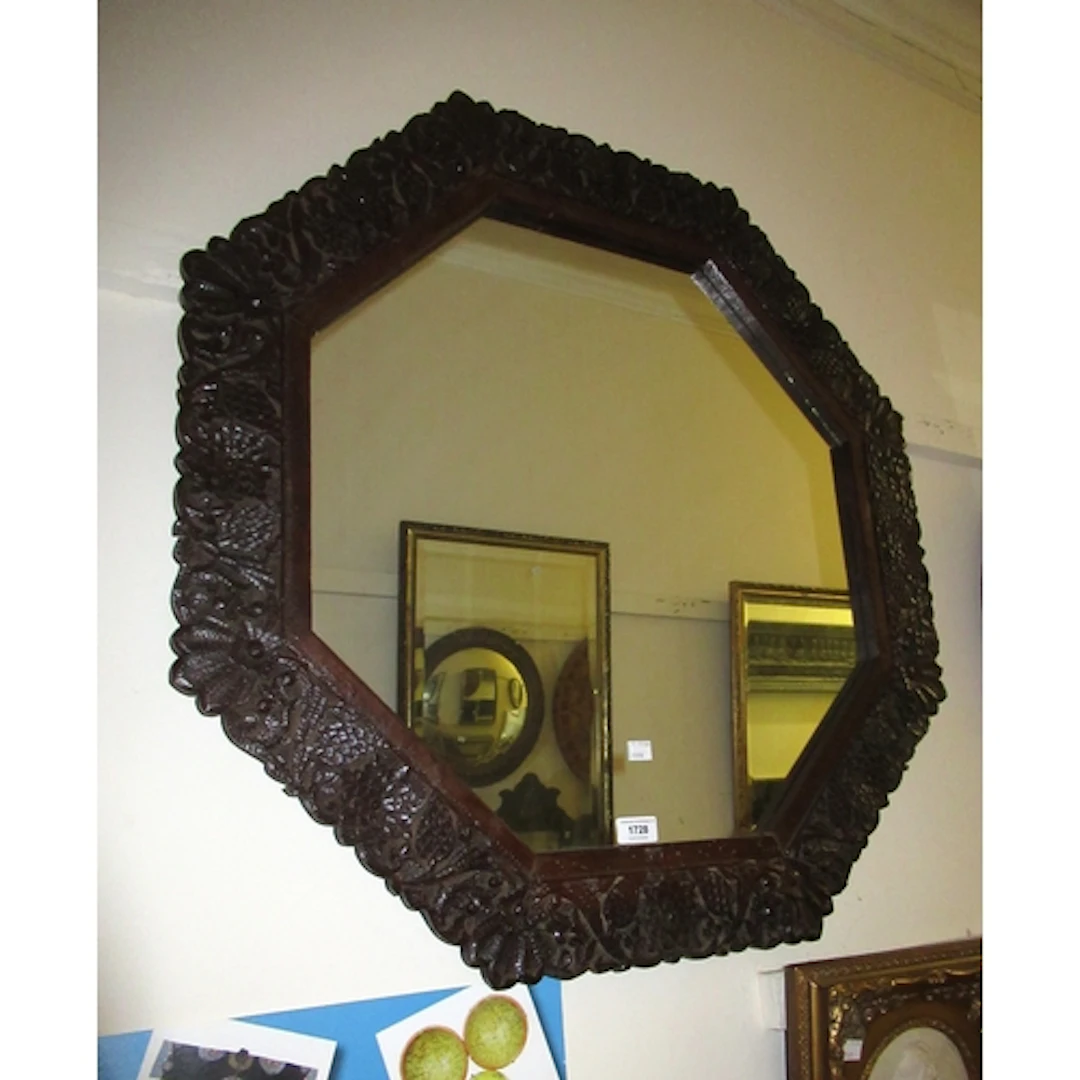 Indian carved hardwood octagonal wall mirror, 77cm wide, tog...