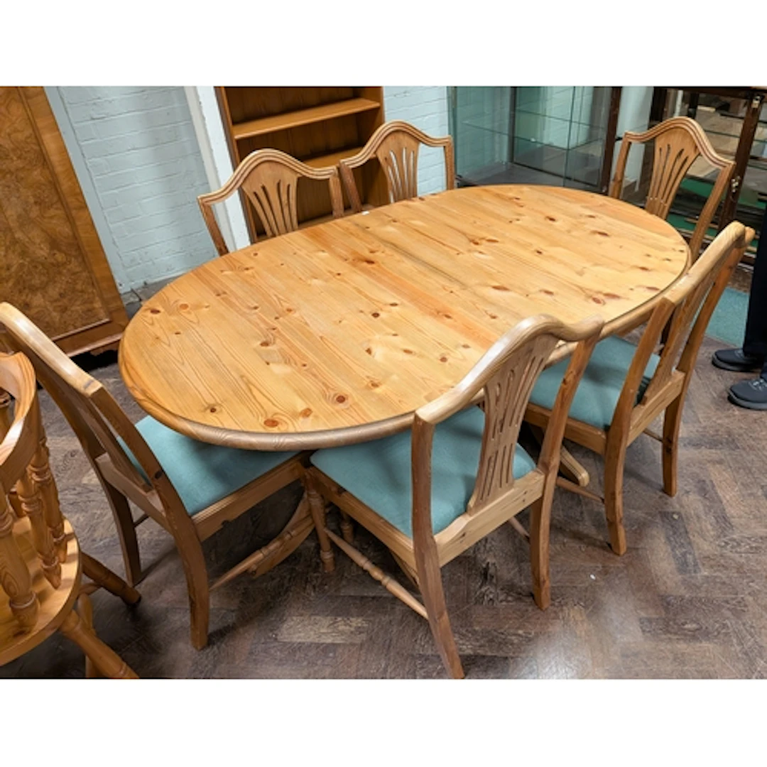 An oval twin pillar pine dining table and a set of six pine ...