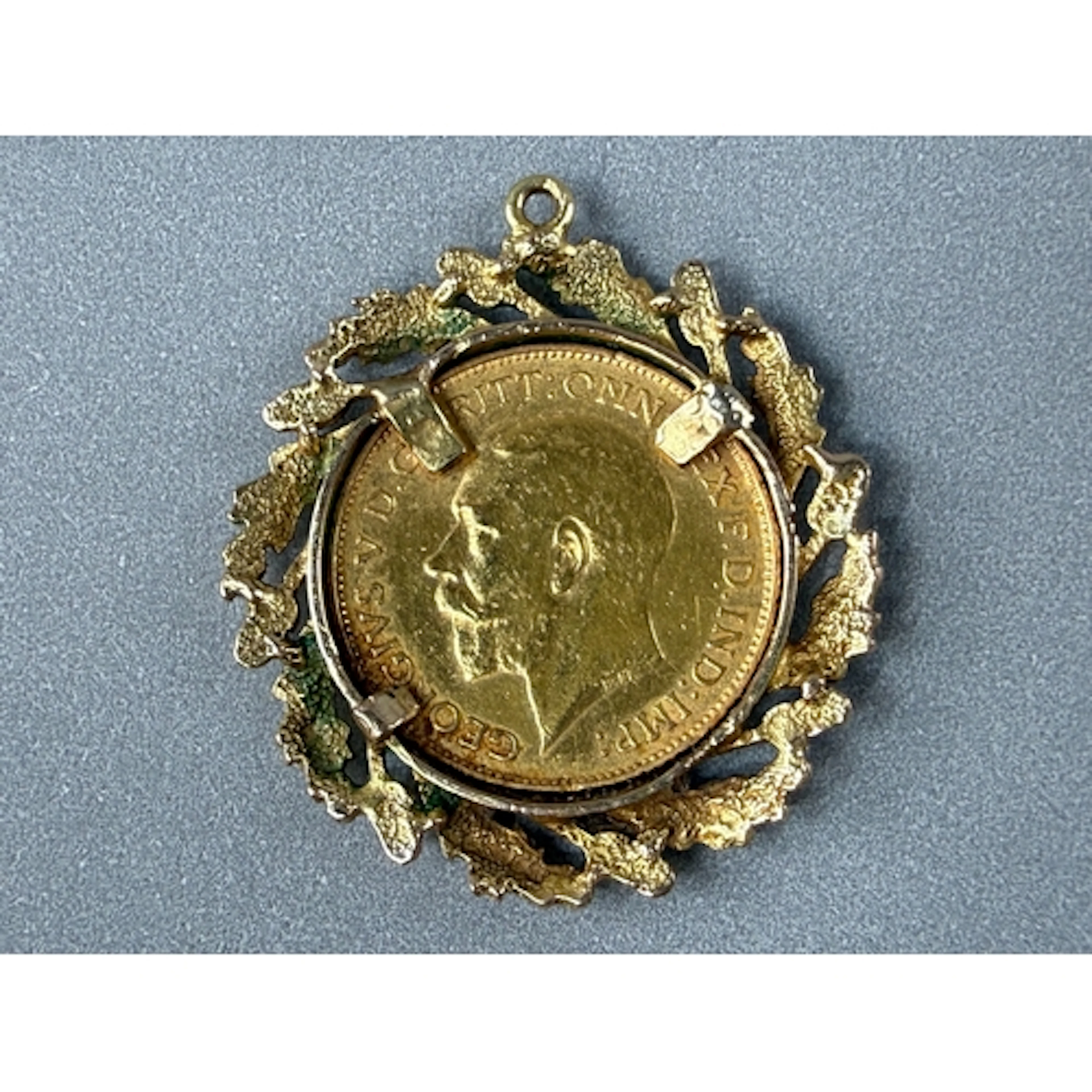 Coins: a 1925 George V half sovereign, circulated, in 9ct go...