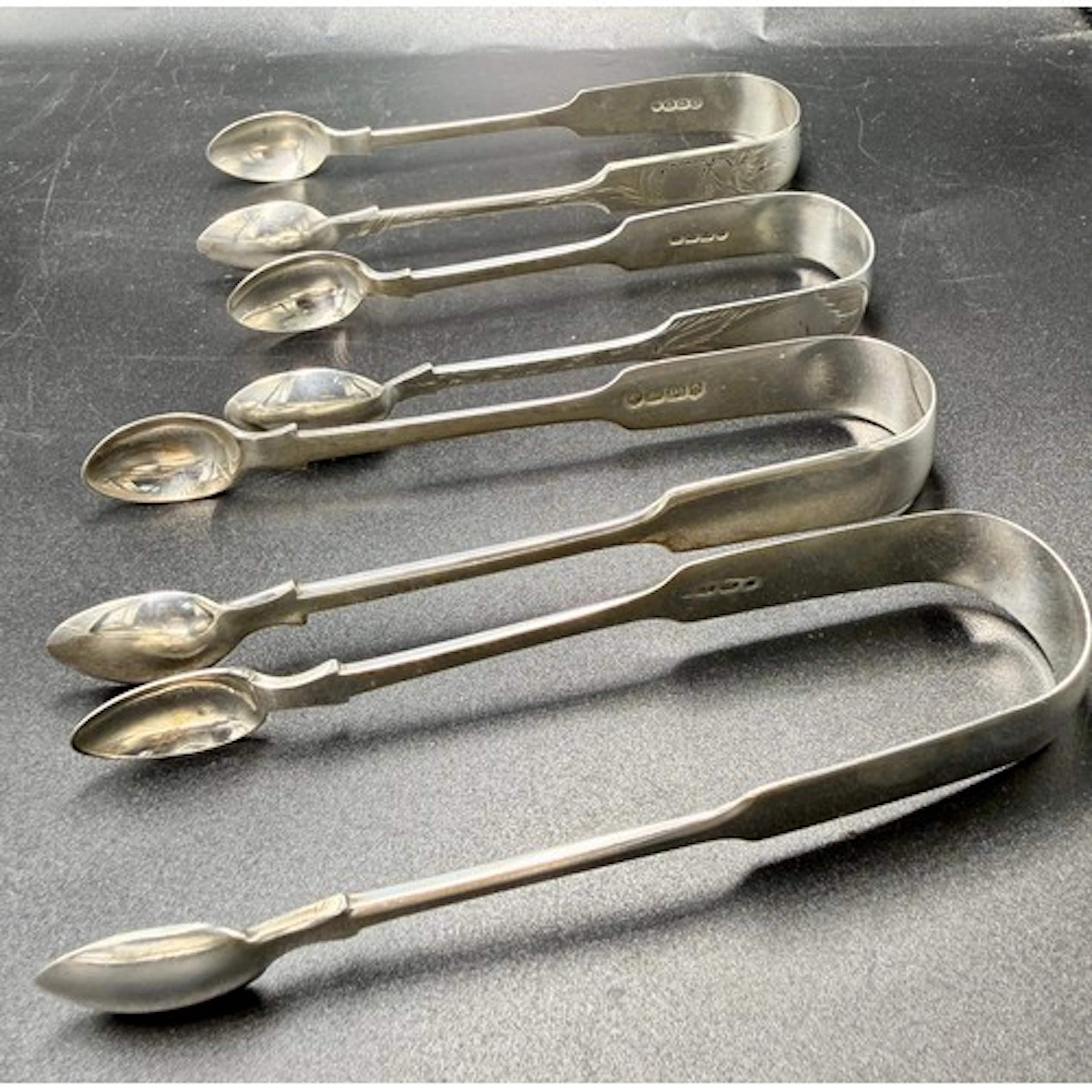 Four pairs of Victorian Exeter silver sugar tongs to include...