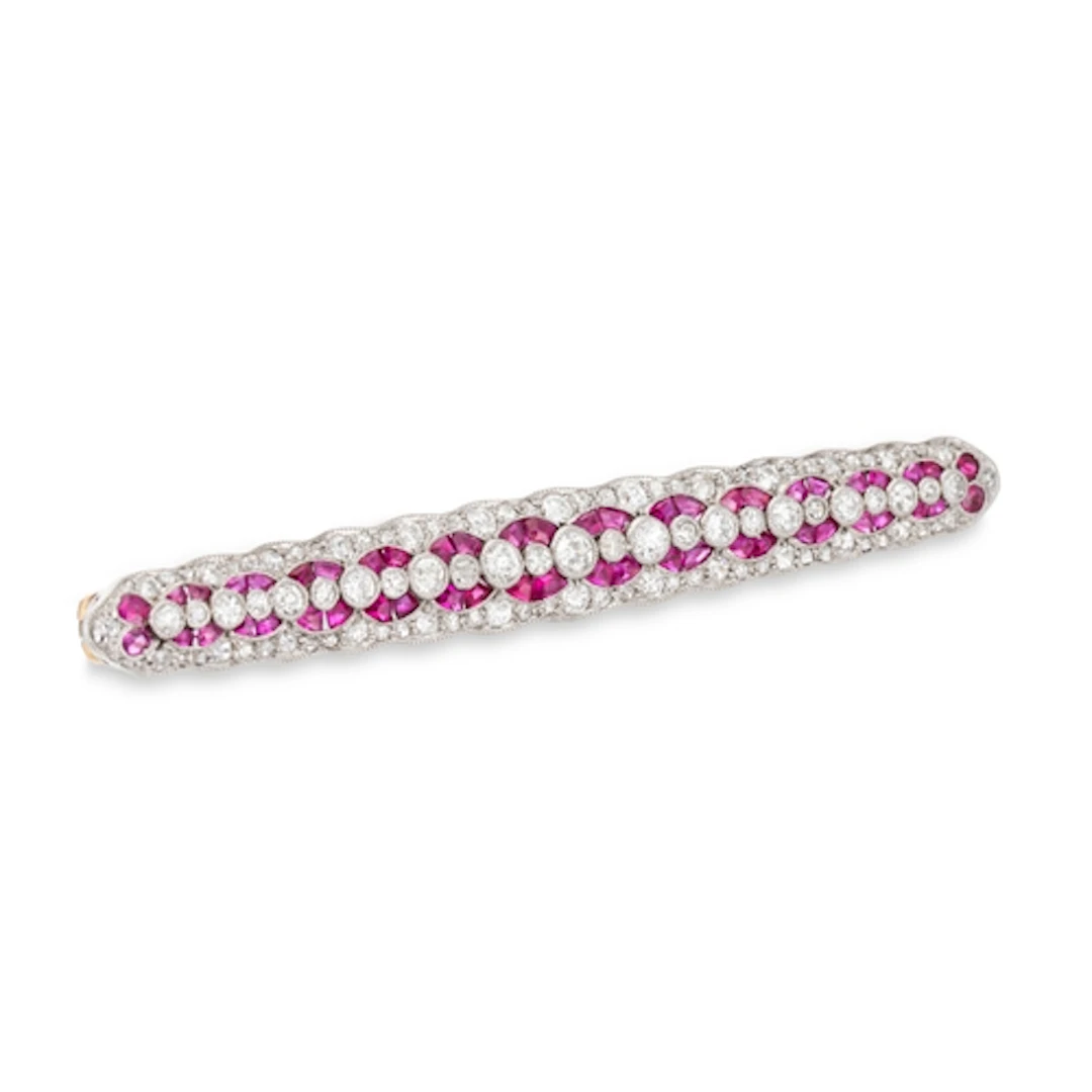 AN EARLY 20TH CENTURY RUBY AND DIAMOND GEOMETRIC ELONGATED B...