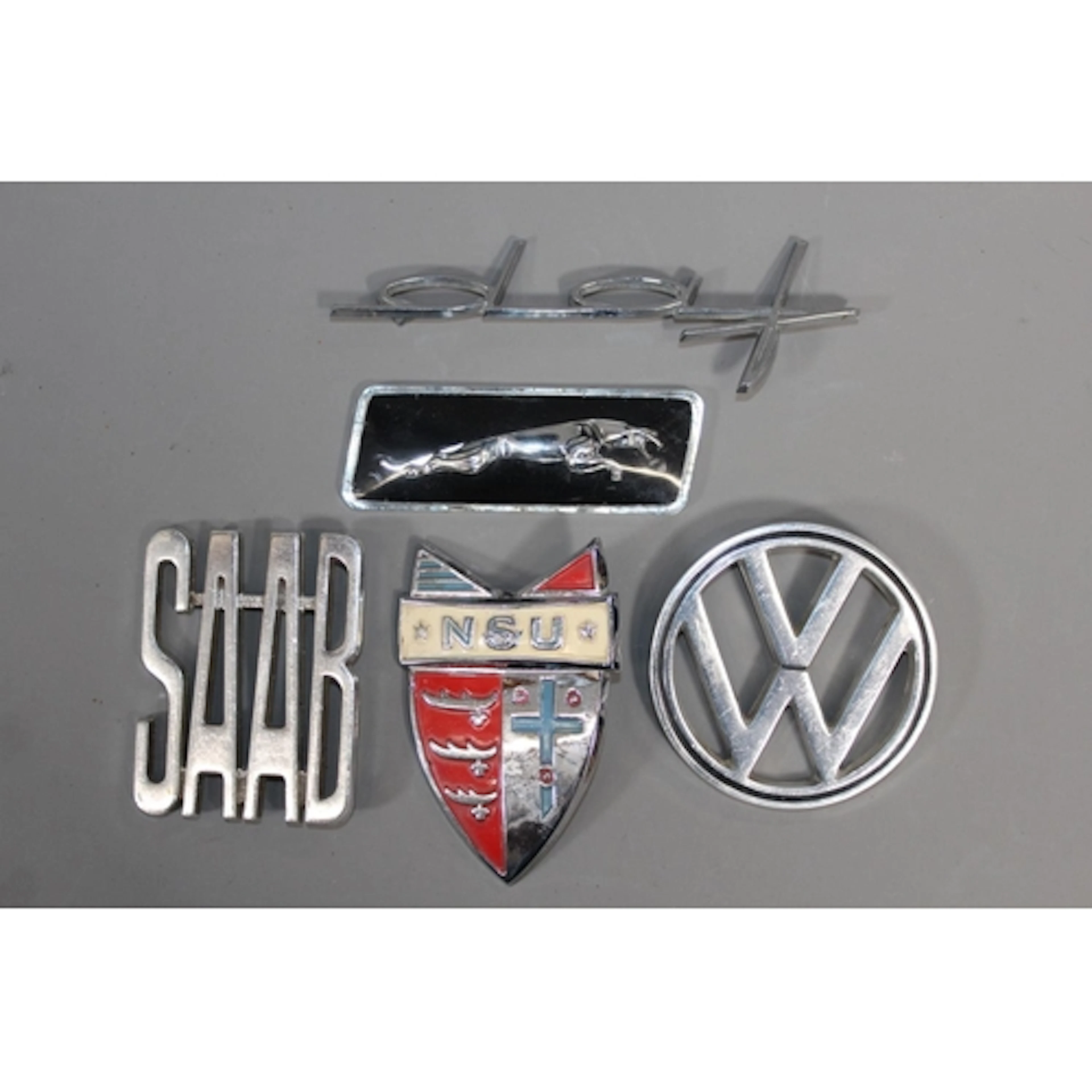 Five car badges to include Saab, Volkswagon, NSU, Jaguar and...