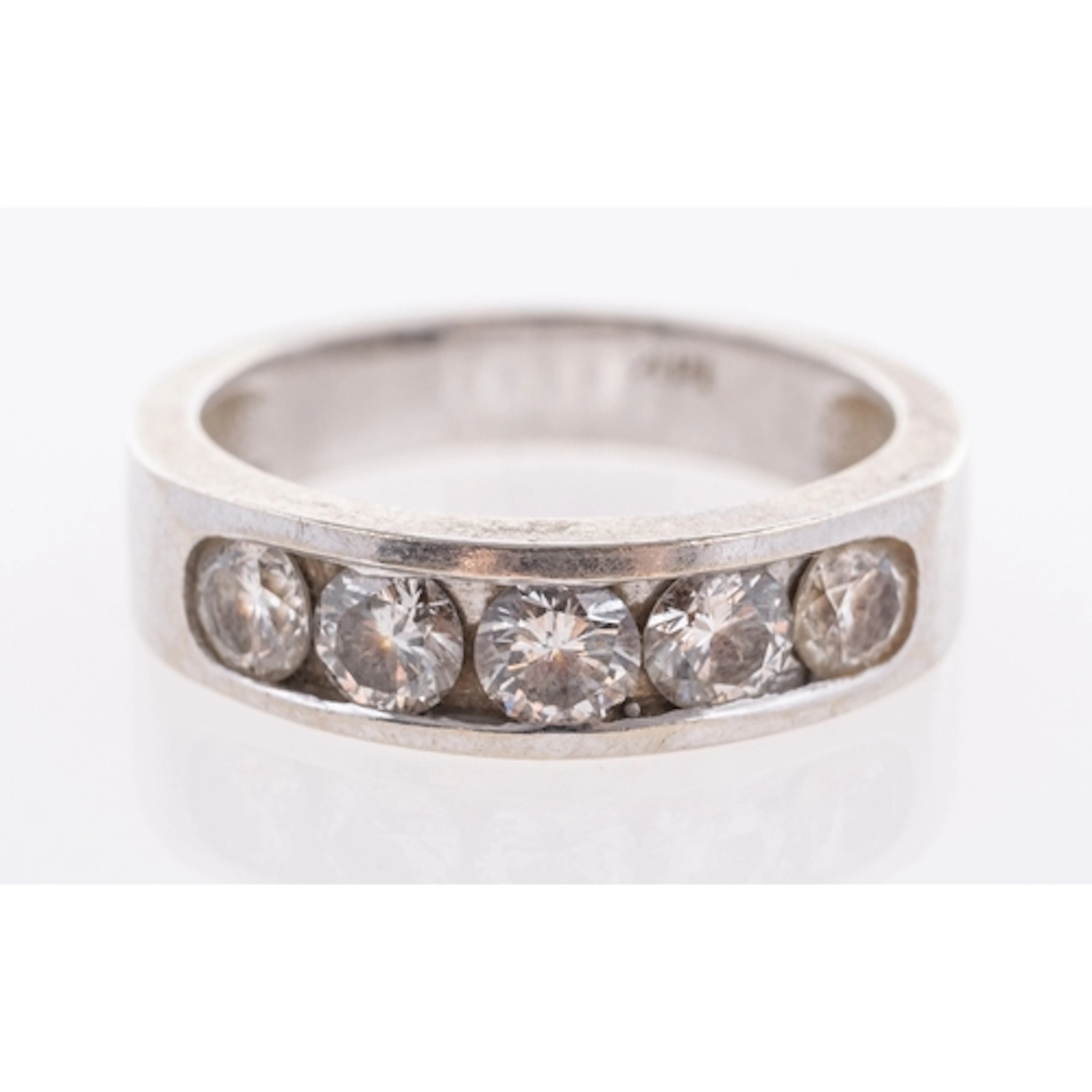 A channel set diamond five stone ring in 14k marked white me...