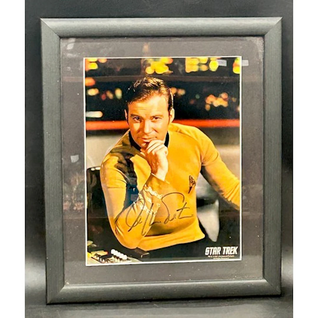 A signed photograph of William Shatner as Captain Kirk, 33cm...
