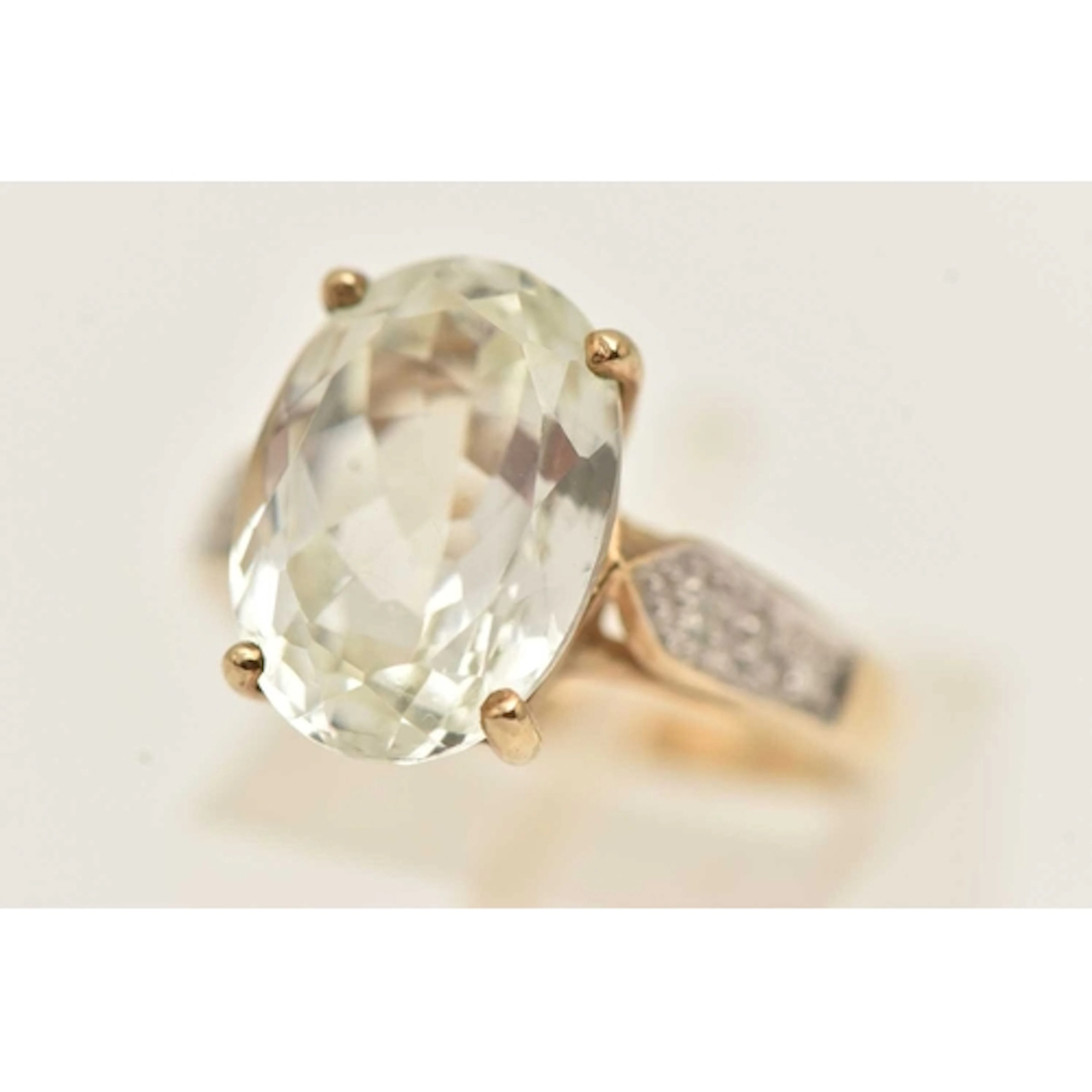A 9CT GOLD GEM SET RING, large oval cut colourless stone, po...