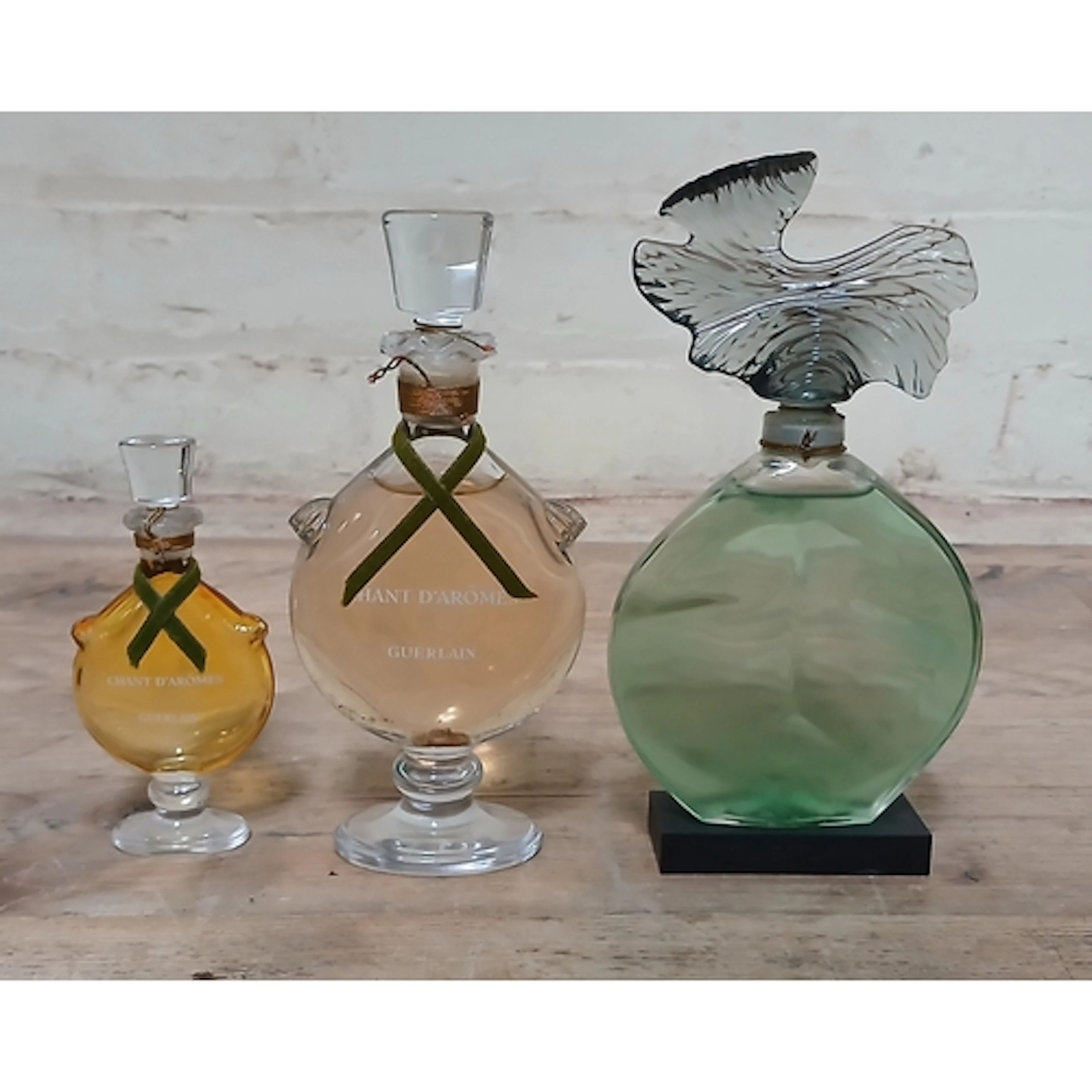 Guerlain, a group of three vintage perfume bottles and conte...