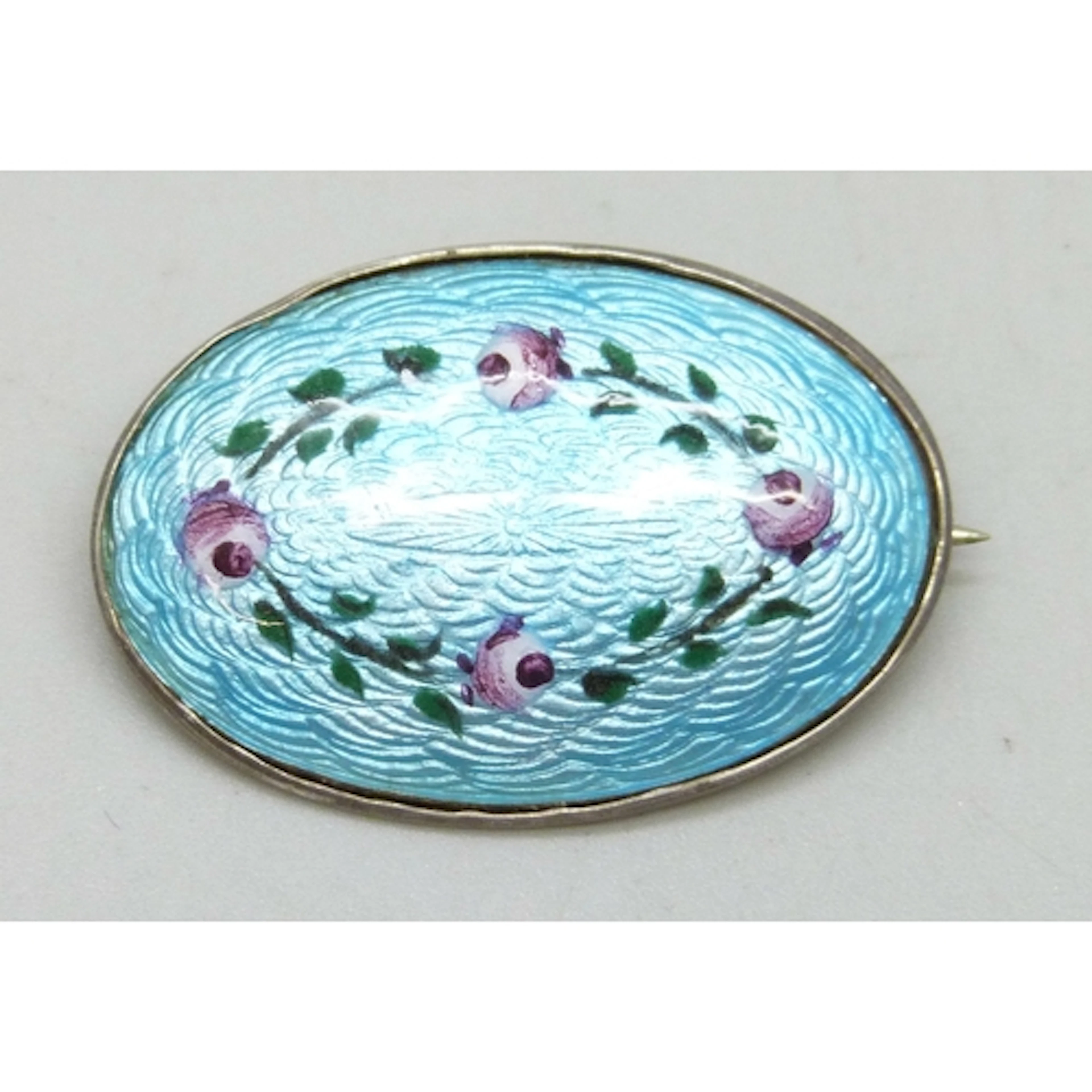 An early 20th century silver and enamel brooch with hand pai...