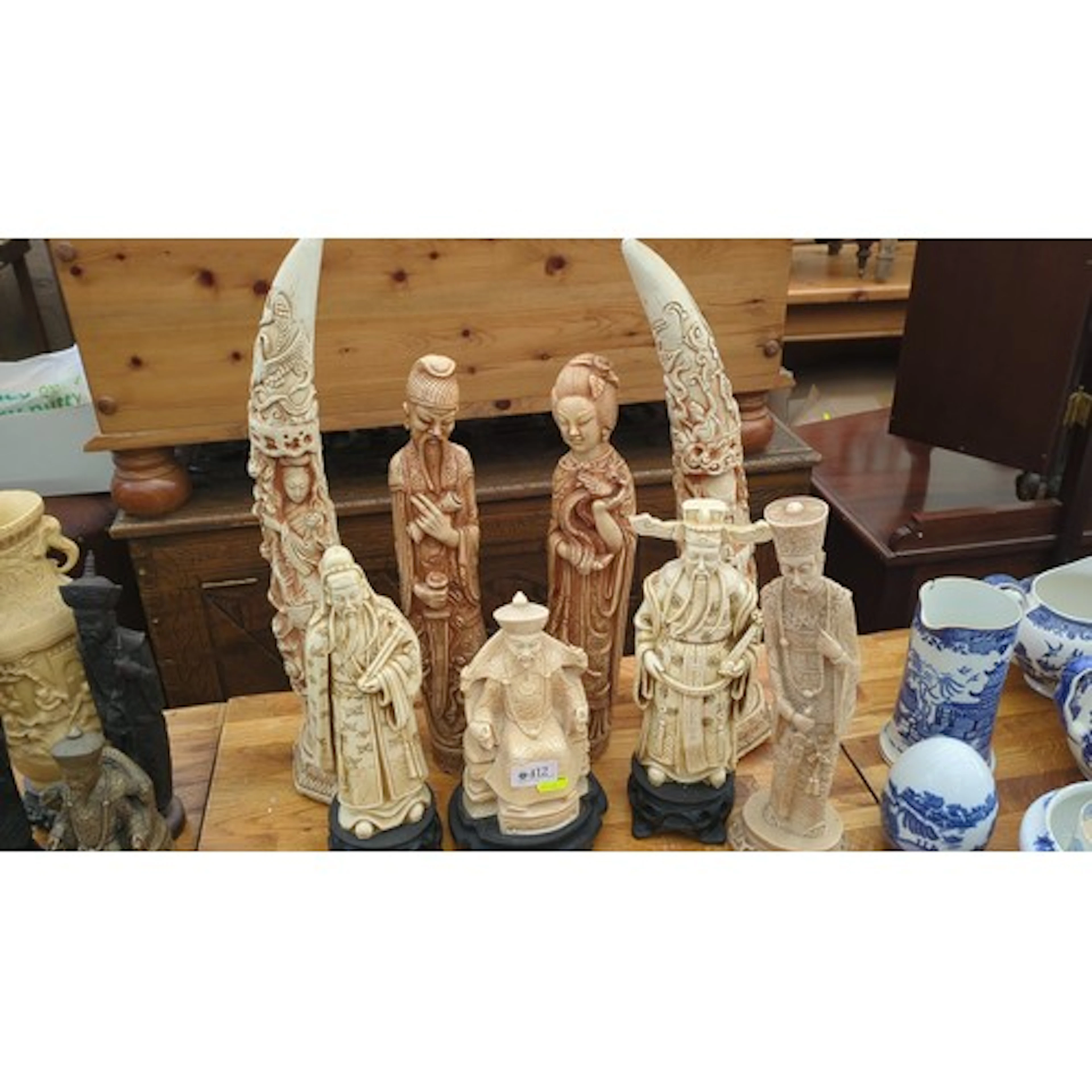 A group of Asian-style carved resin figures including schola...
