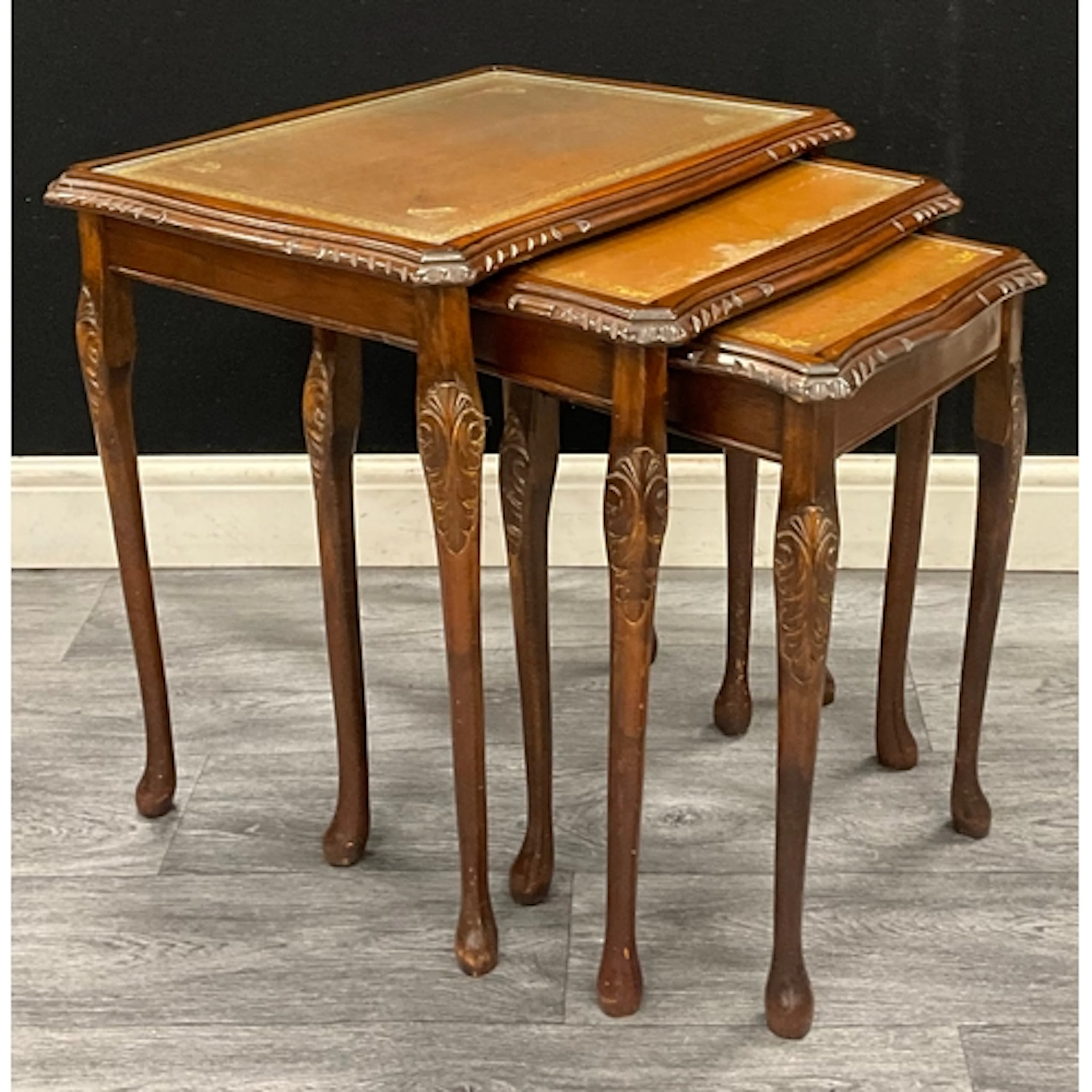A Queen Anne revival mahogany nest of tables, green leather ...
