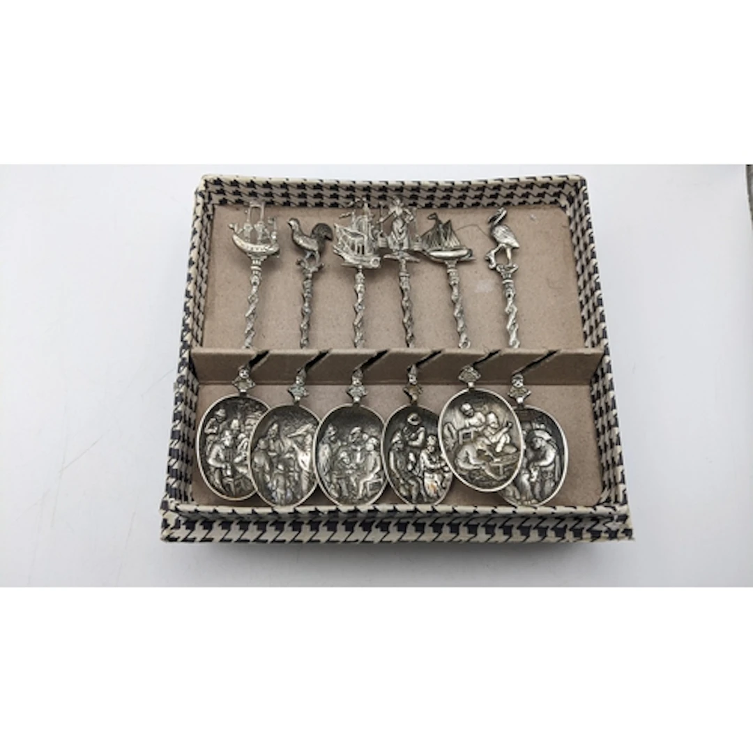 A boxed set of six Dutch white metal teaspoons, each with a ...