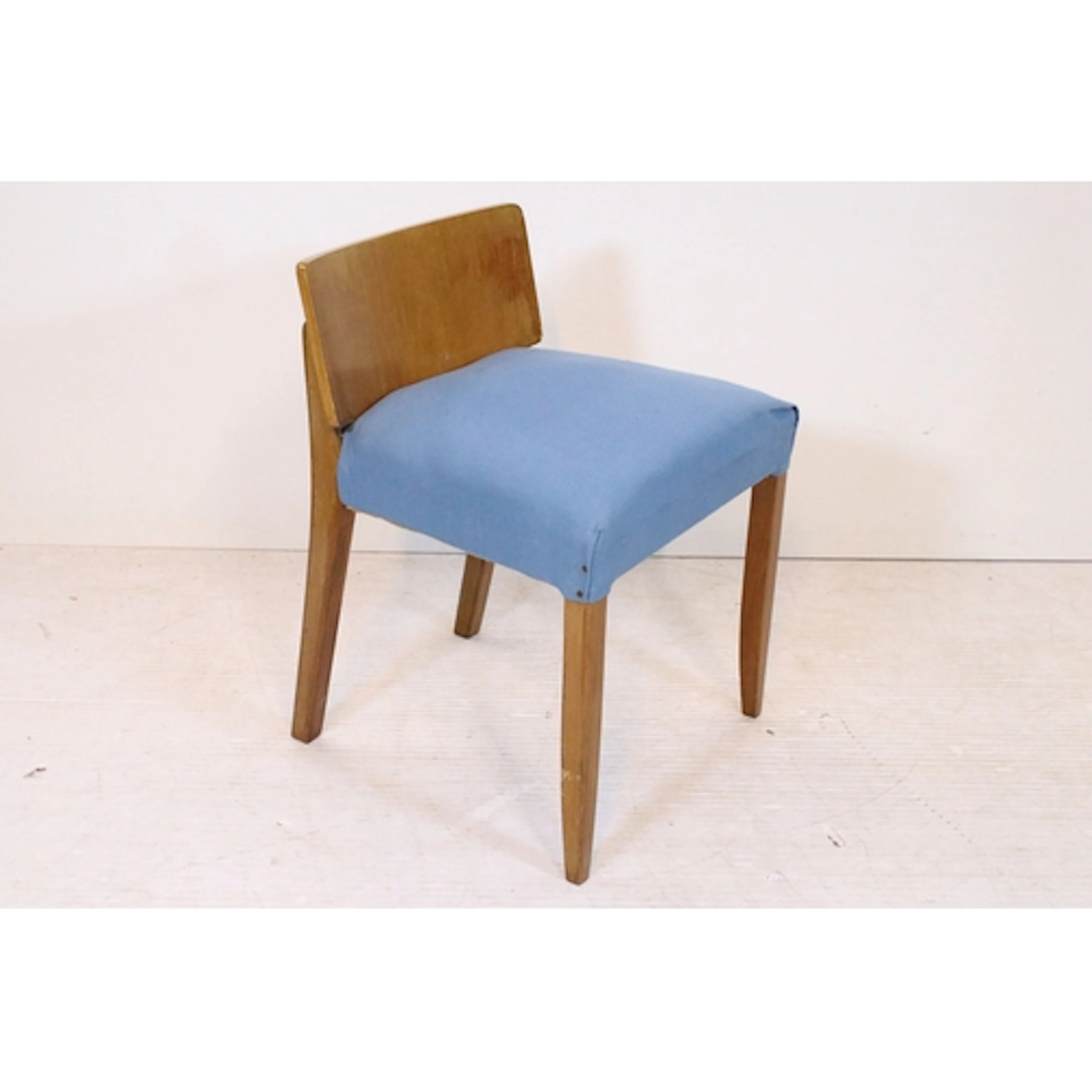 Mid century teak chair with low back, above blue upholstered...