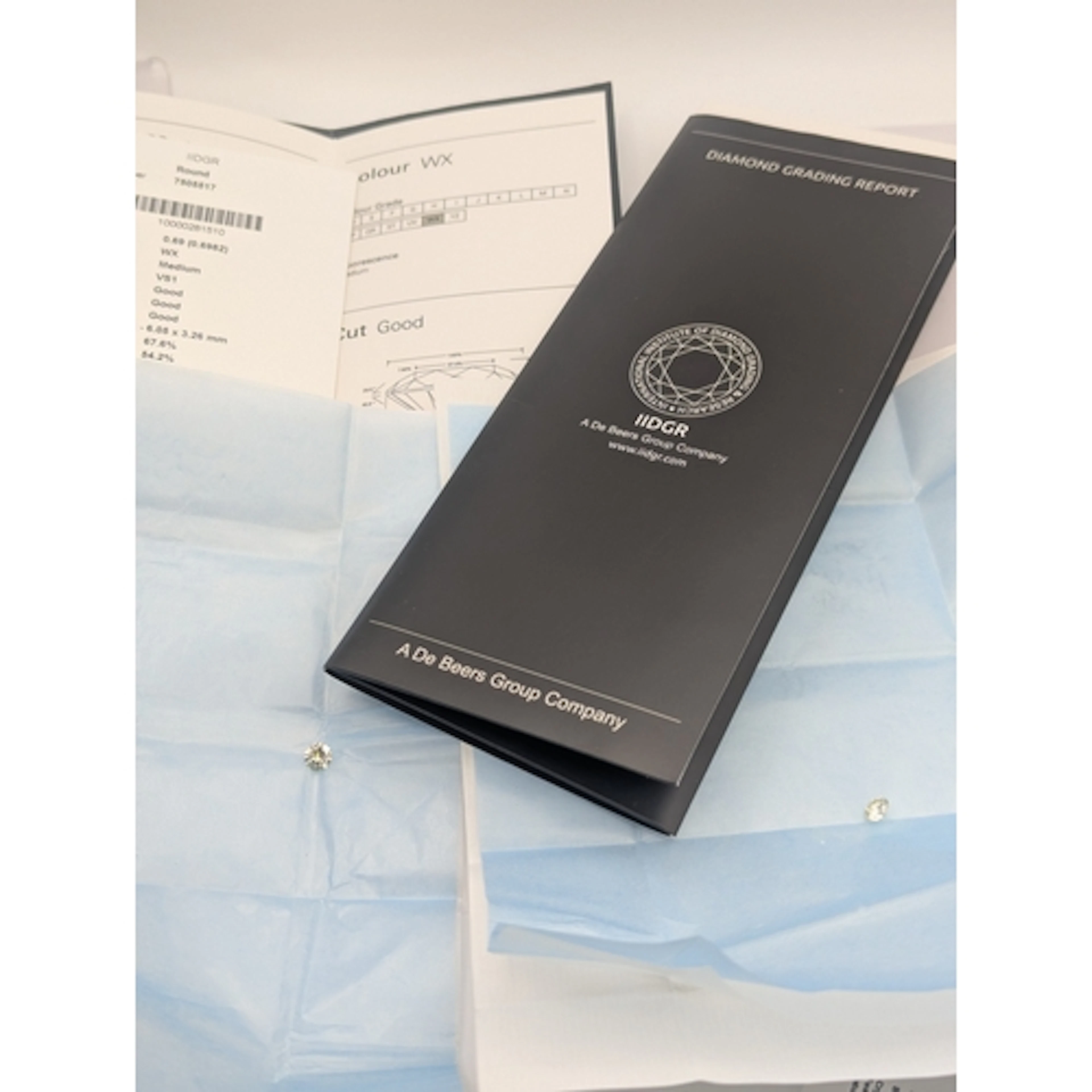 Two diamonds with De beers Grading reports, to include a 0.7...