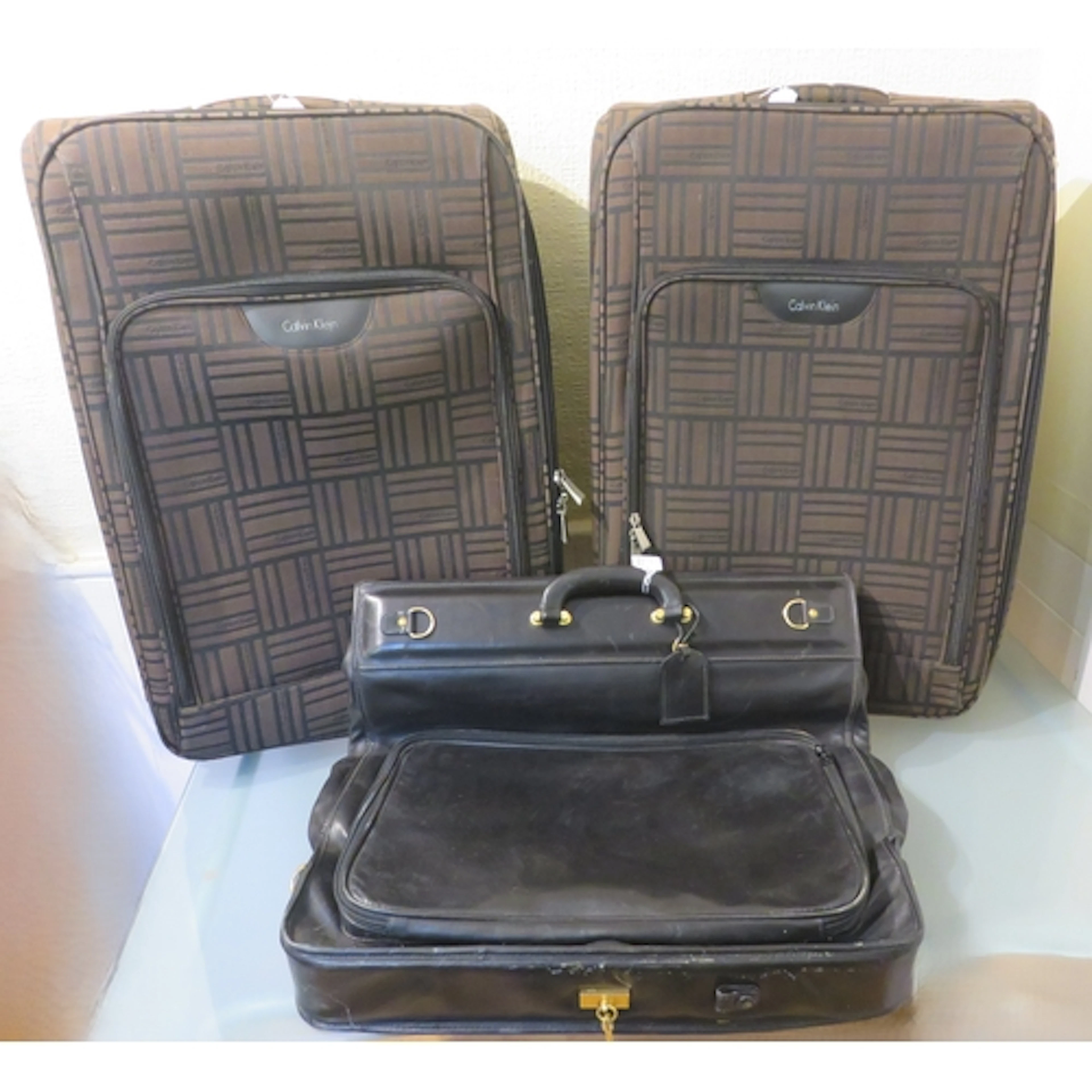 Asprey black leather suit carrier, together with two Calvin ...