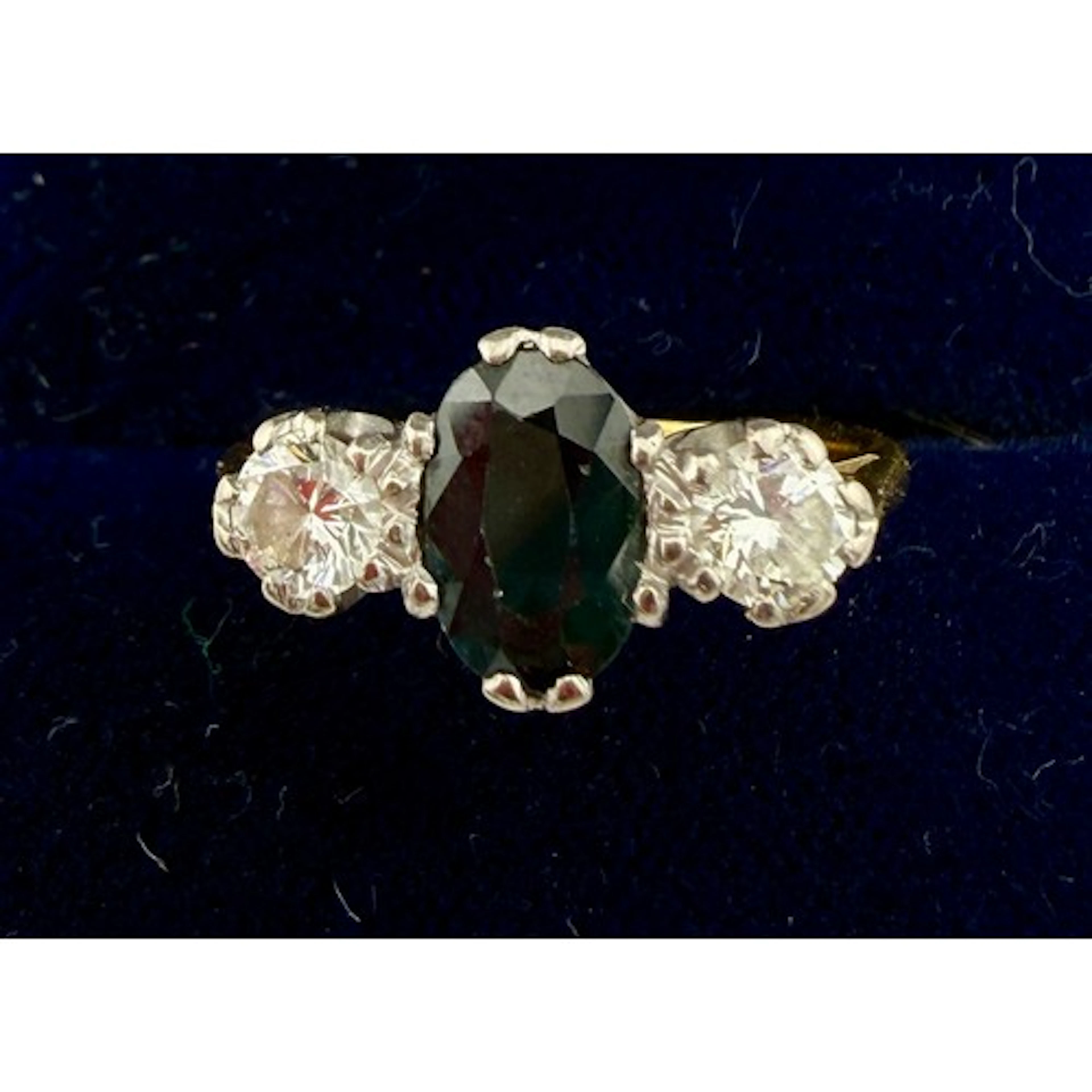 A three stone sapphire and diamond ring on unmarked yellow m...
